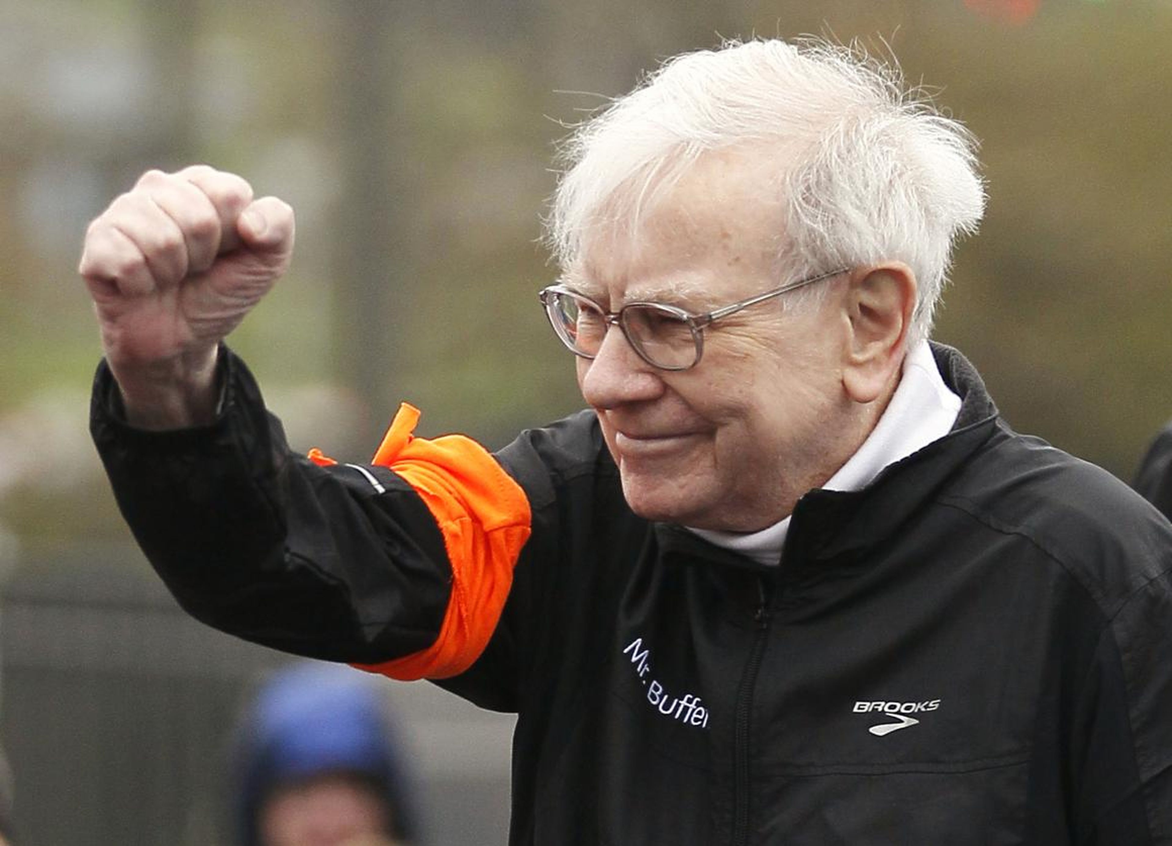 Berkshire Hathaway chairman Warren Buffett gestures at the start of a 5km race.