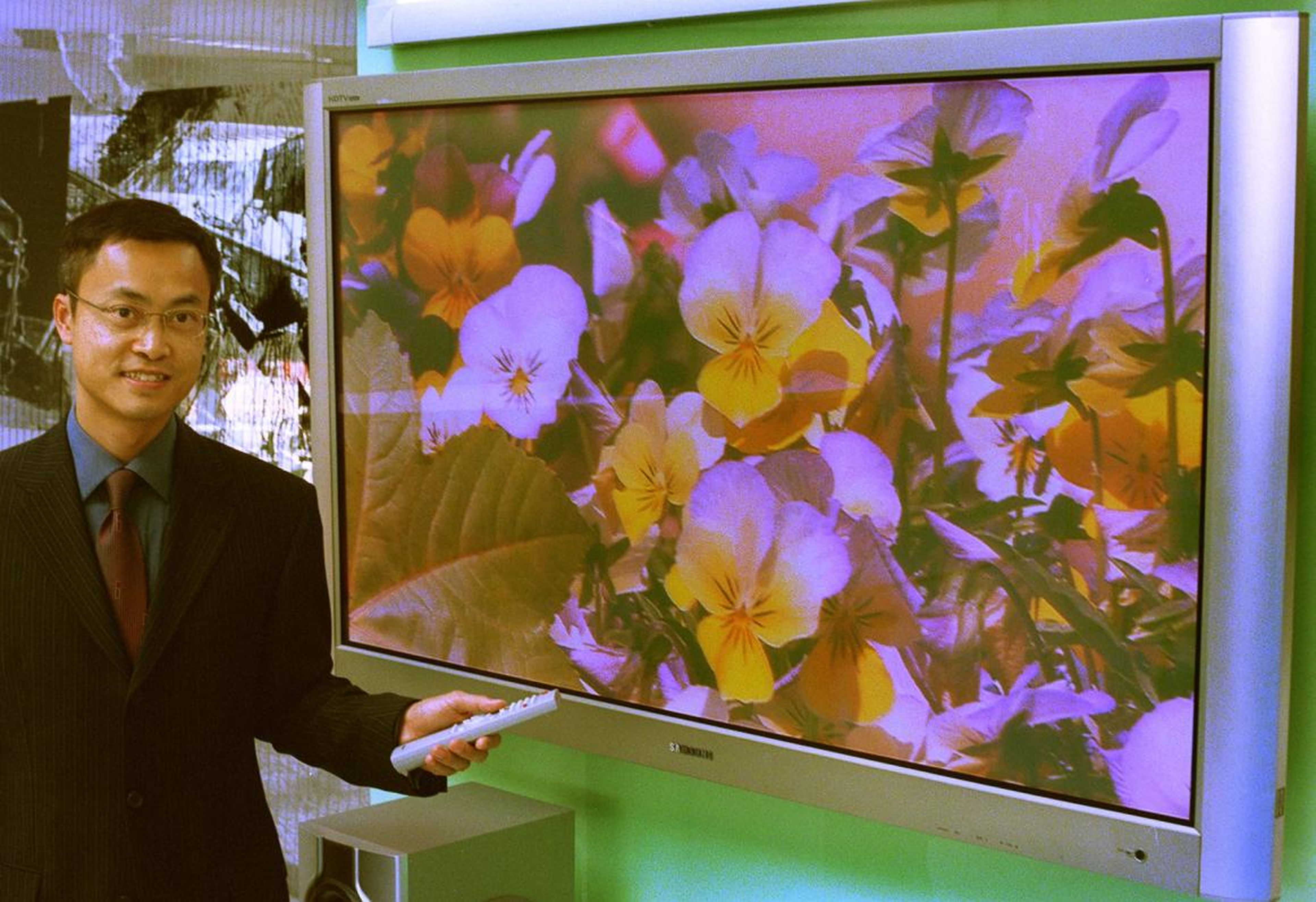 In this 2002 photo, Steven Yu Kam-hon, former Hong Kong General Manager of Samsung Electronics, shows off the company's LCD TV.