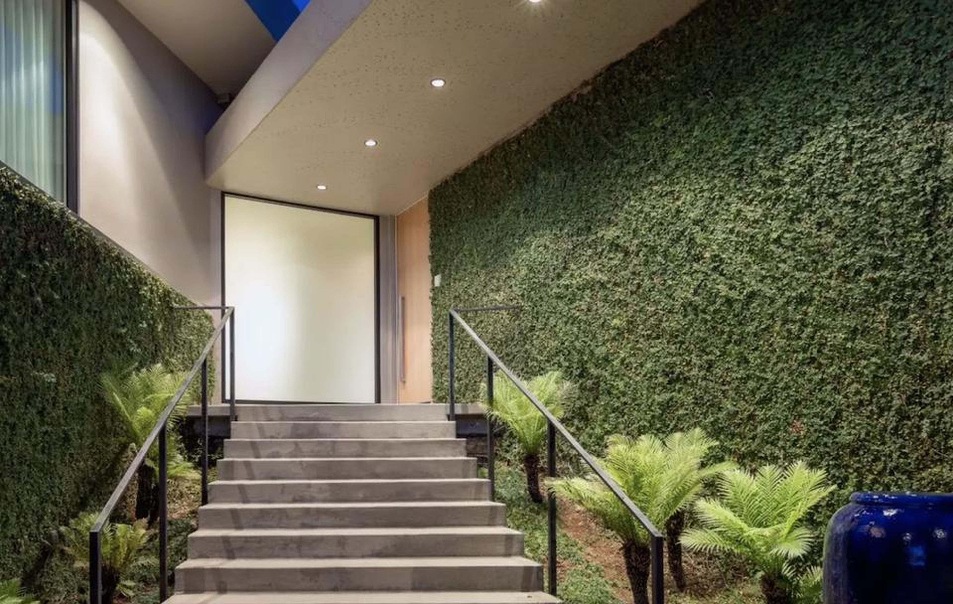 Large privacy hedges help the home stay secluded despite how close it is to the street.