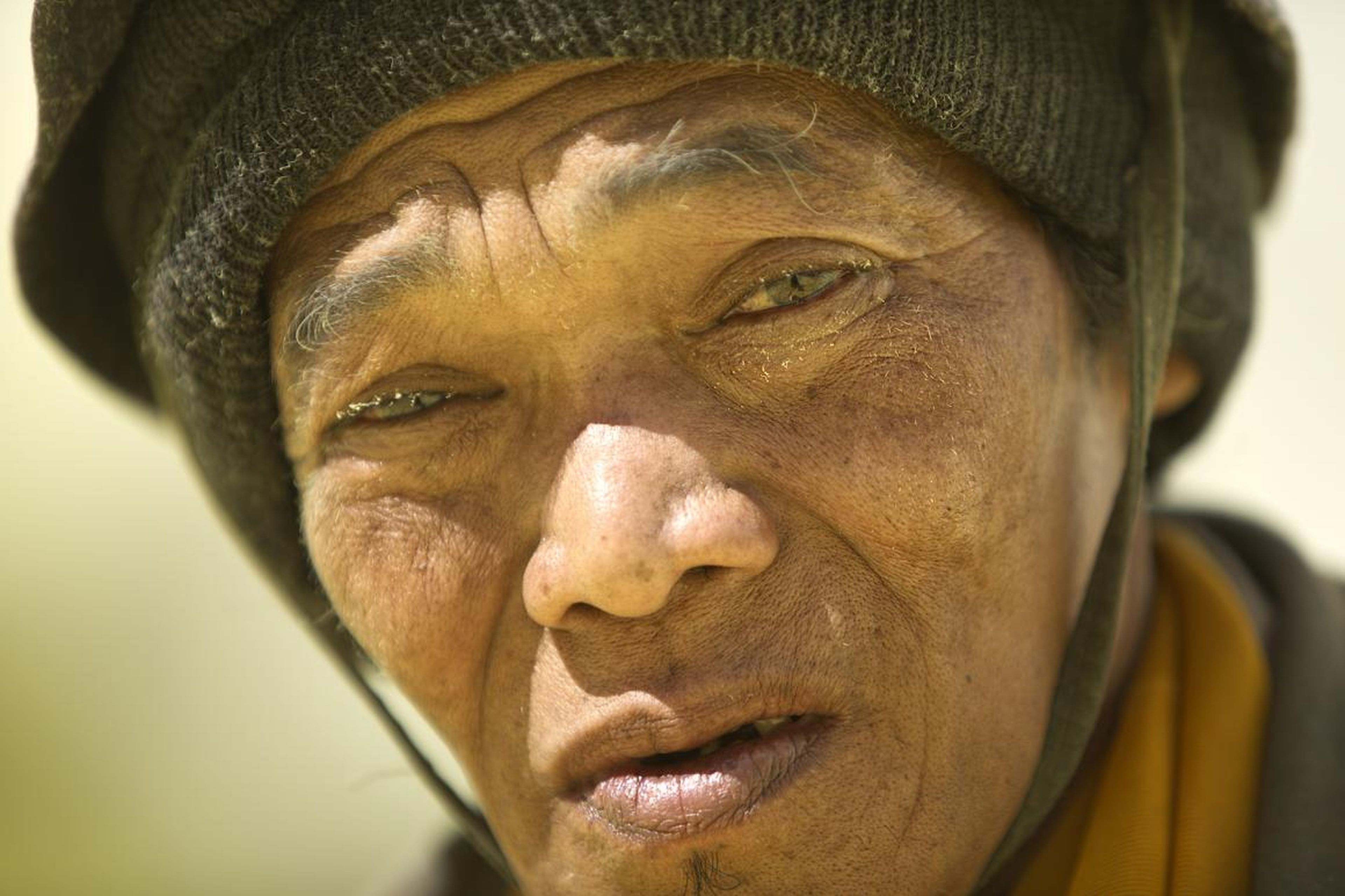 Sulfur particles adorn the eyes and face of this miner in this 2012 photo. "These men were amongst the strongest men that I have ever seen," Brown said.