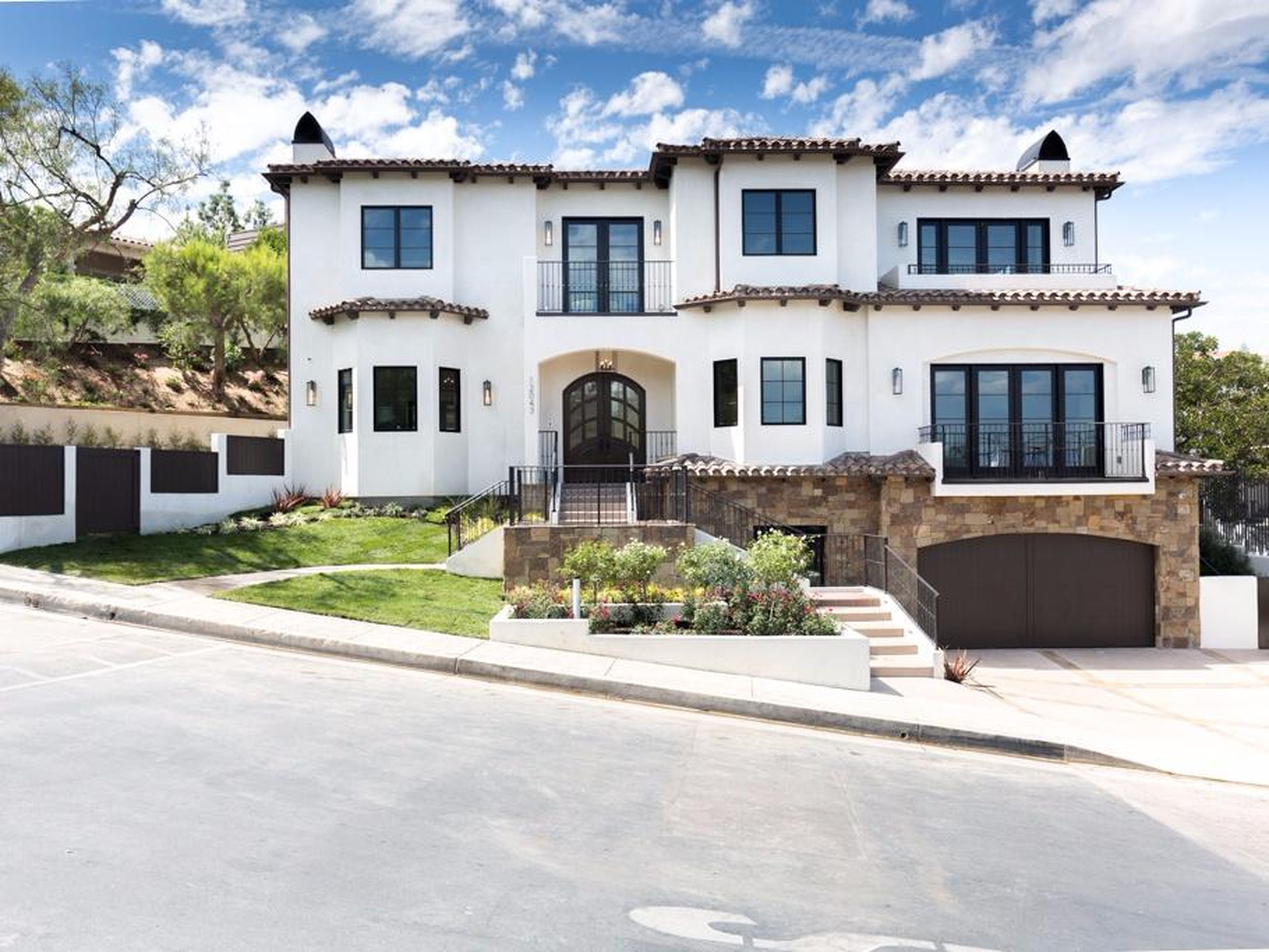 The 6,000-square-foot, three-story Spanish-style residence sits on a quarter-acre lot in a gated community.