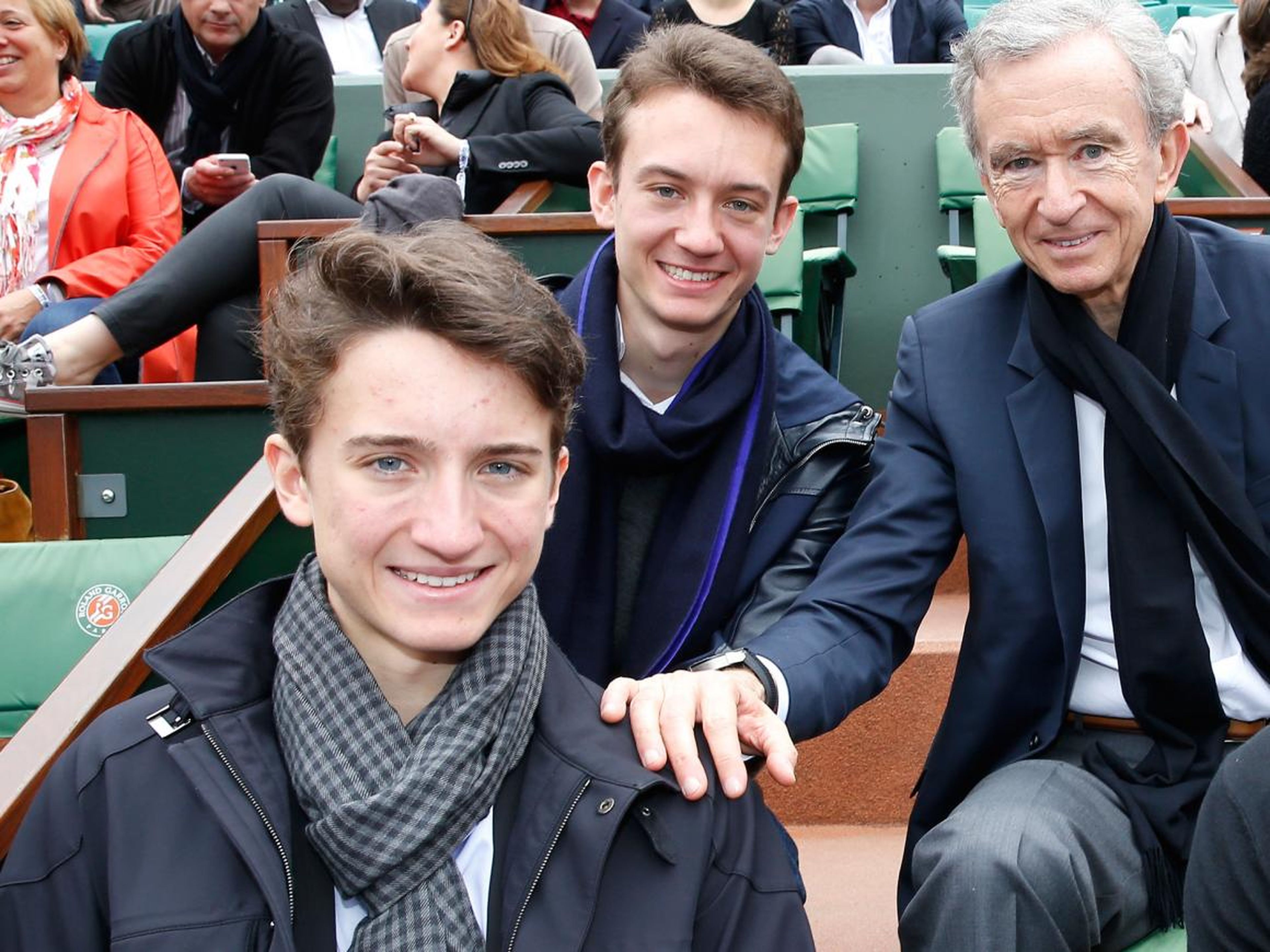 Jean Arnault (front left) with his brother, Frederic (center) and father, Bernard (right).