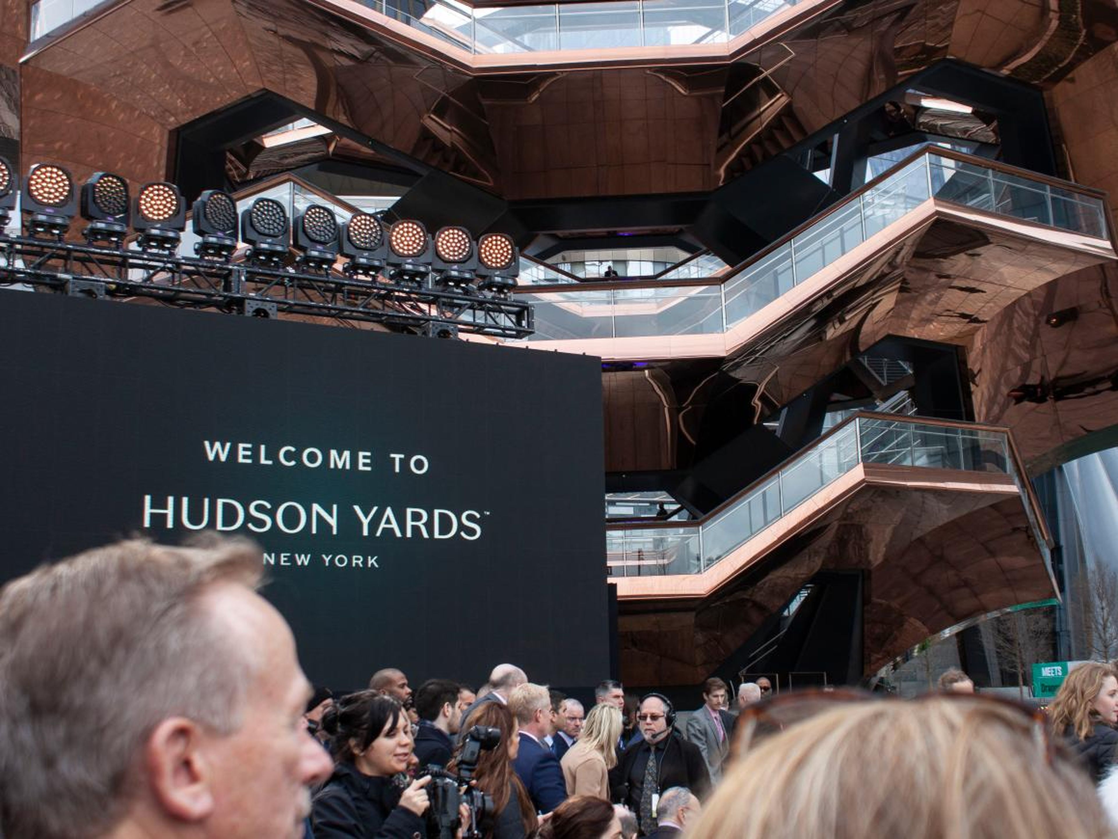 People gathered in Hudson Yards' central plaza for the morning's opening event. Chairs and a stage were set up for the planned performances and speeches from notable New Yorkers.