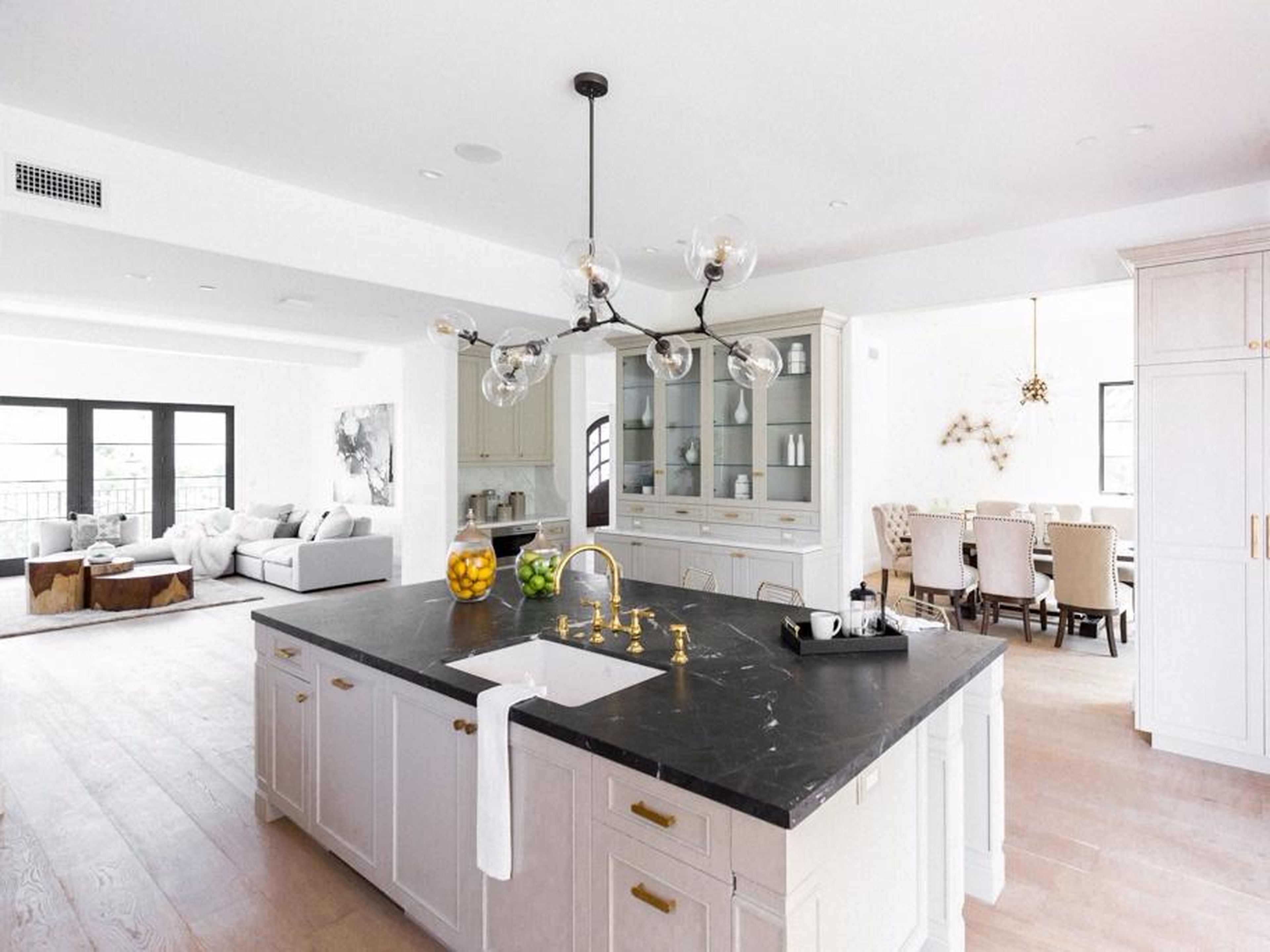 The floors are brushed oak, and the kitchen — which opens out onto a veranda — has marble countertops.