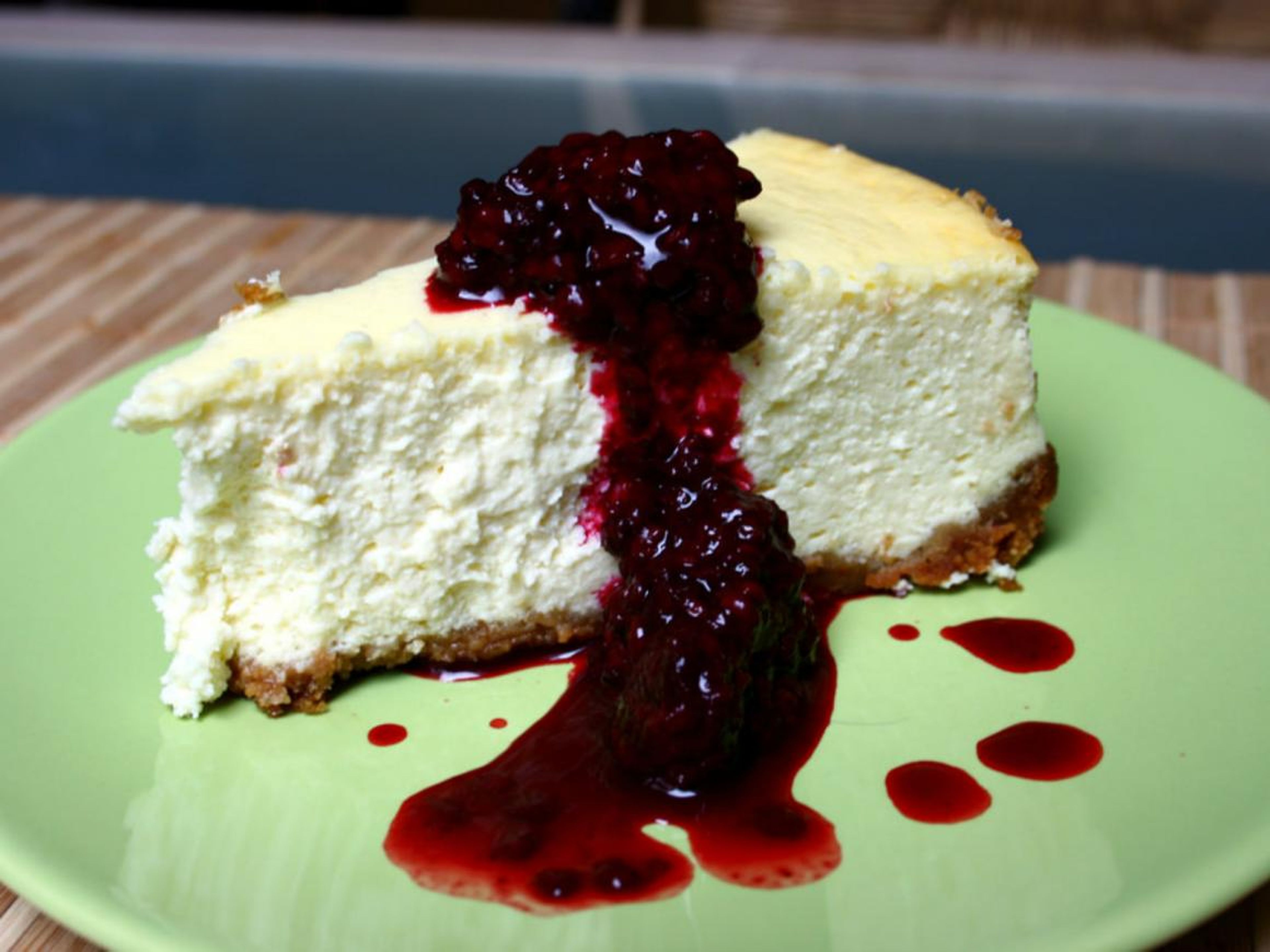 Creamy cheesecake topped with blackberry sauce.
