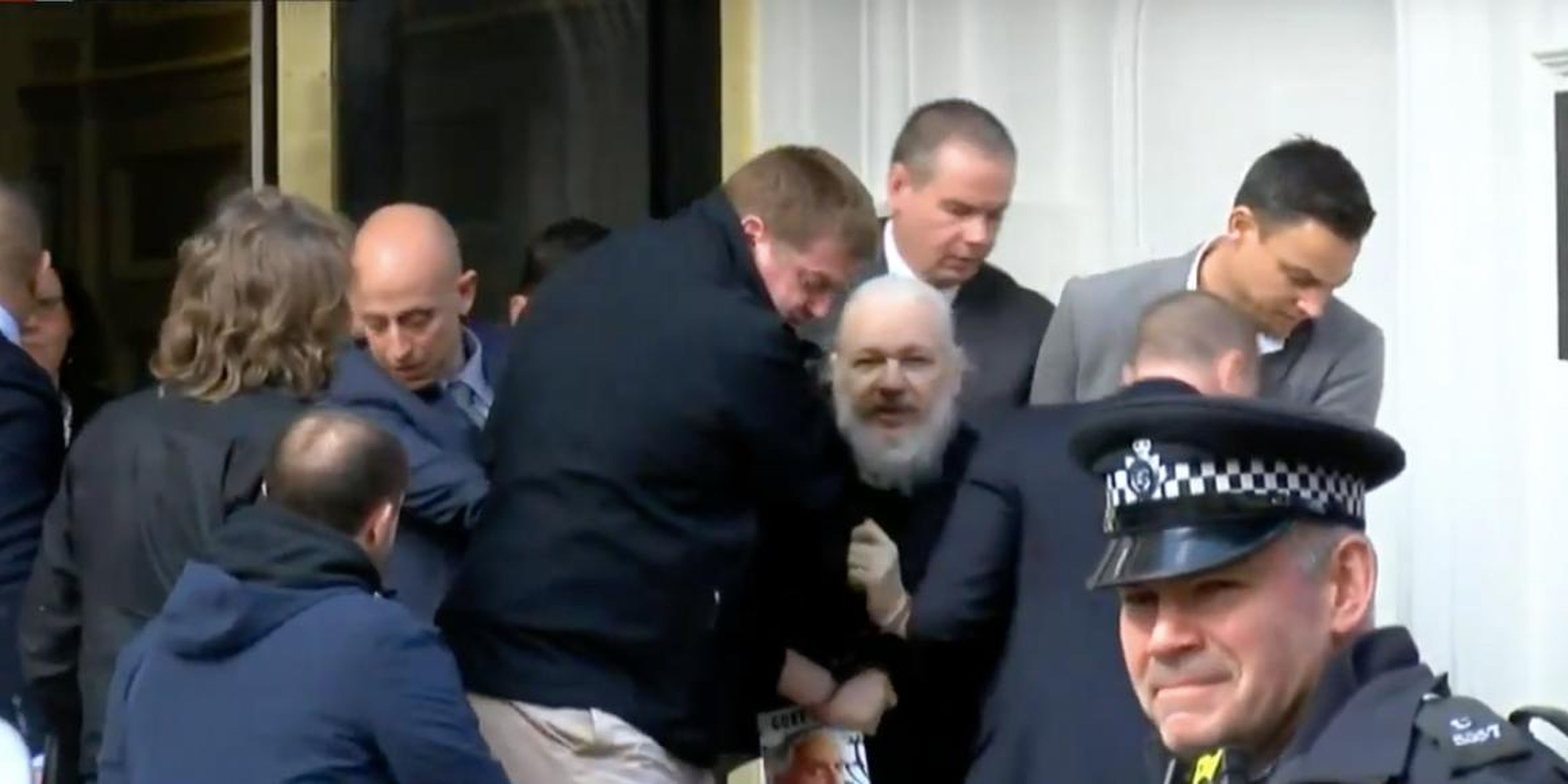 Julian Assange, center, being removed from Ecuador's embassy in London, April 11, 2019.