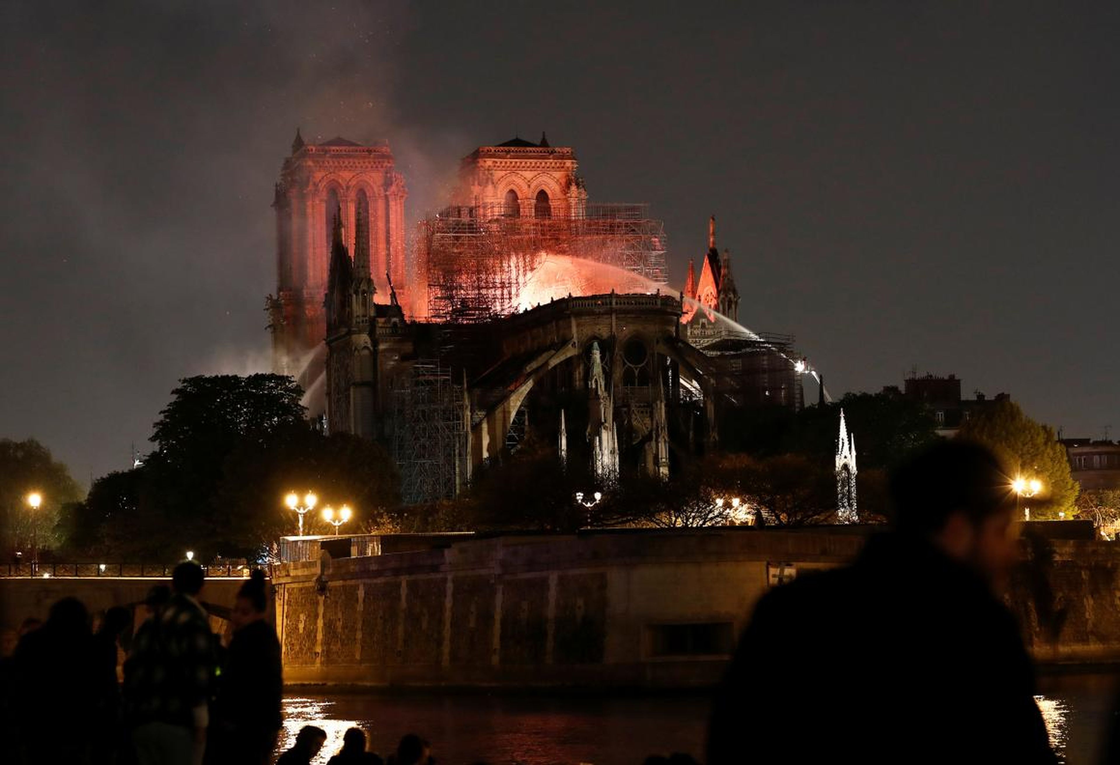 Firefighters dousing flames from Notre-Dame Cathedral in Paris on Monday.