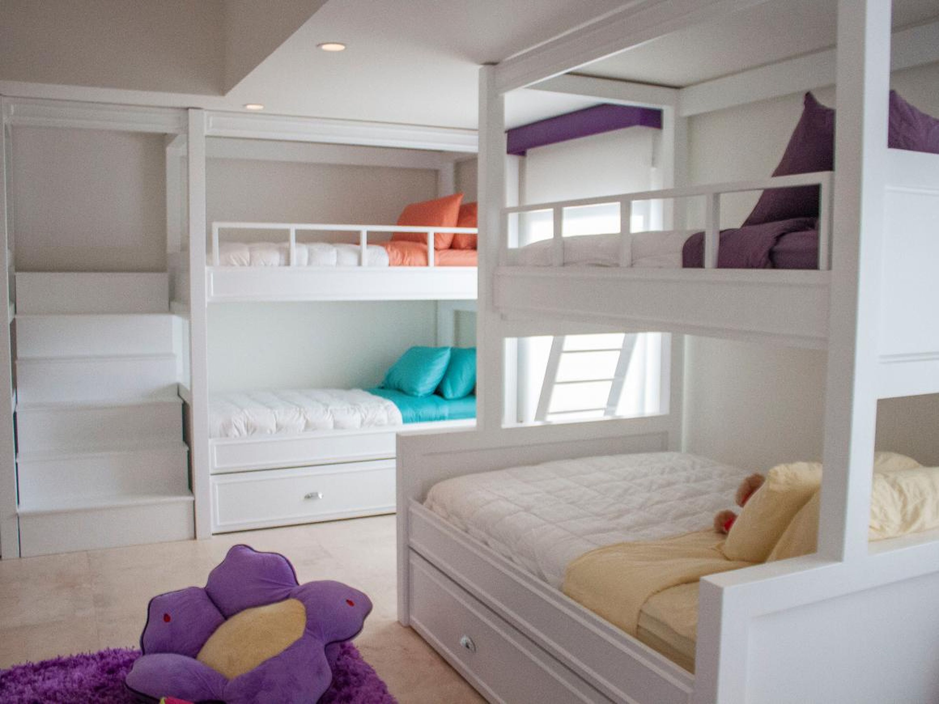 And a downstairs bedroom is arranged as a children's slumber-party room, with several bunk beds.