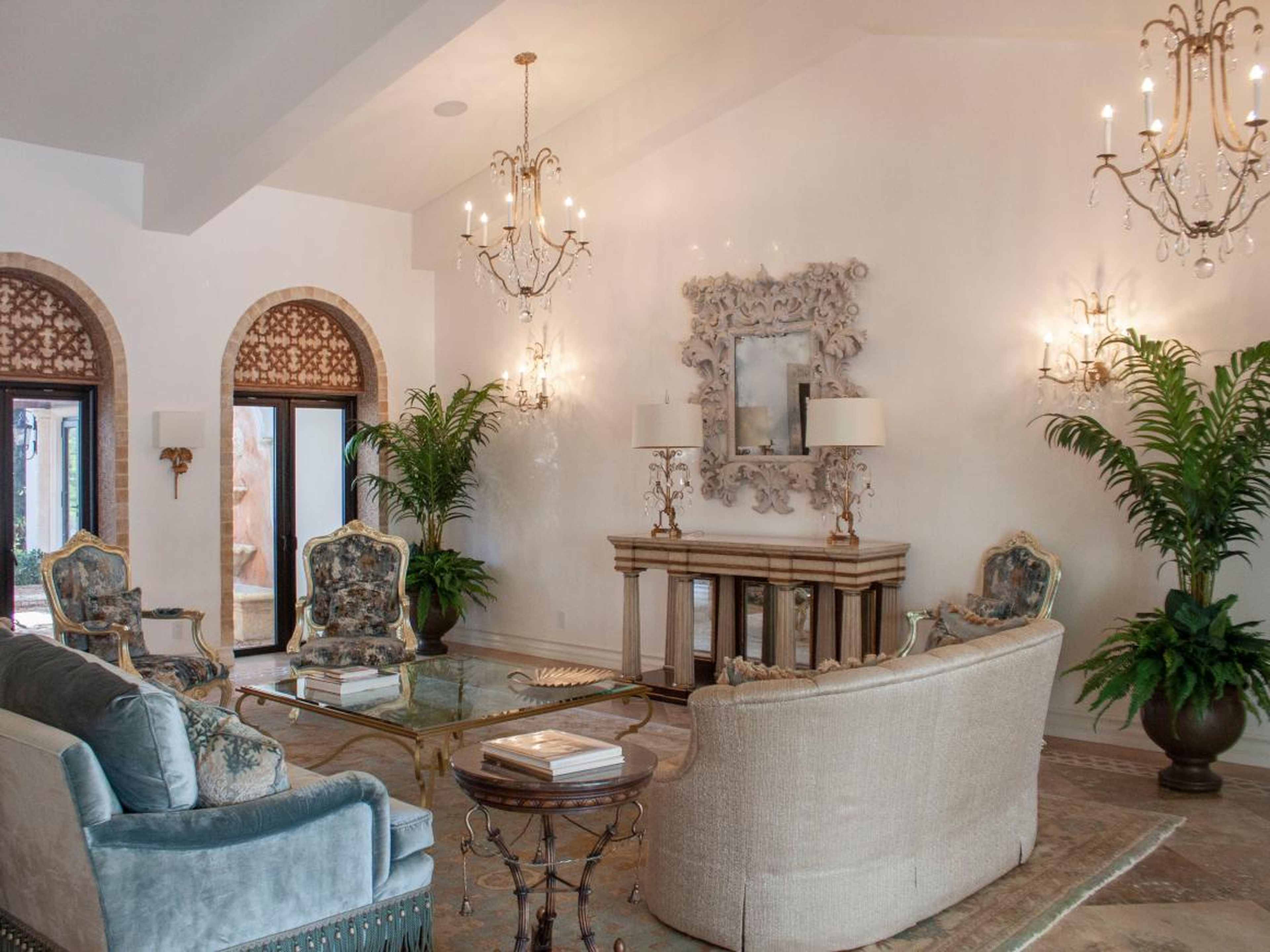 The home is opulently decorated, with high ceilings and chandeliers.