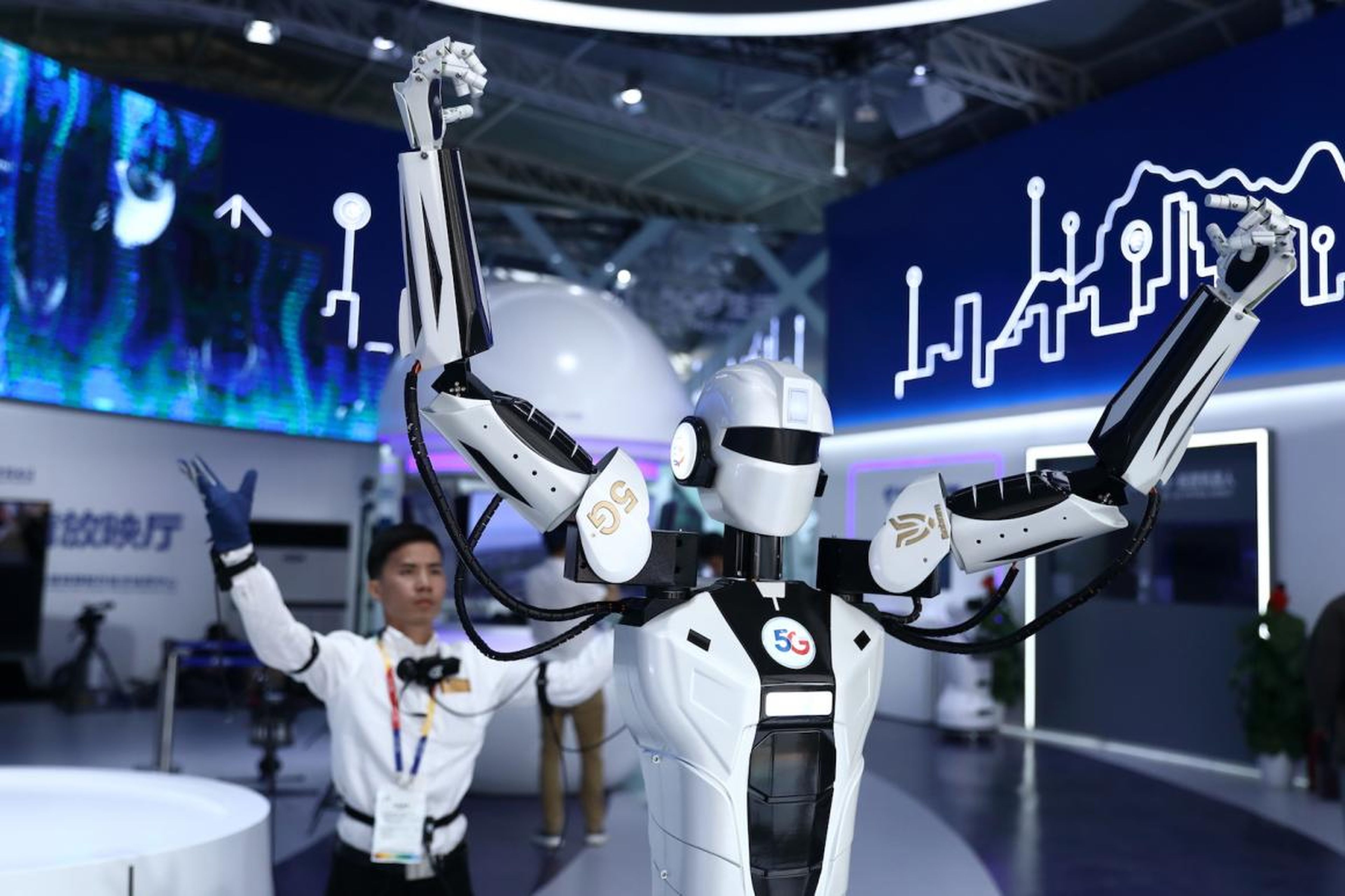 An intelligent robot copies the movement of a visitor wearing sensor suit during the opening of 2019 Beijing International Horticultural Exhibition.