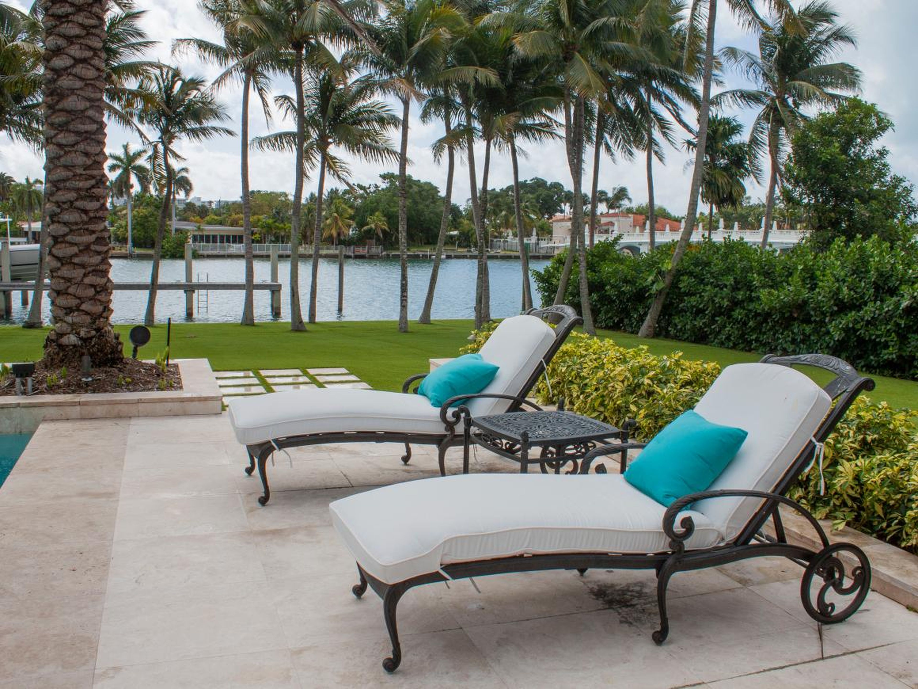 Several lounge chairs are scattered throughout the pool area.