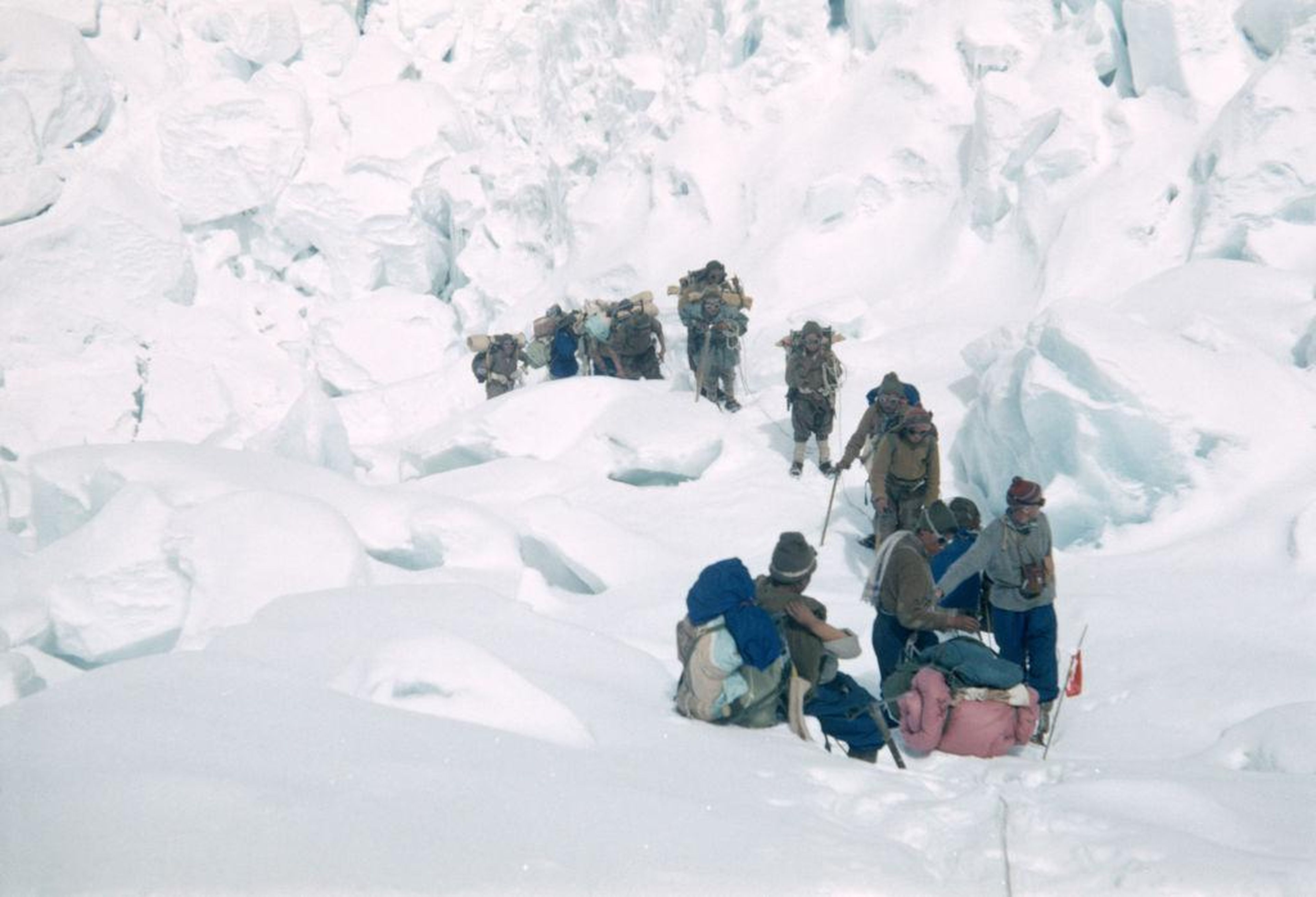 Una fila de sherpas llevando suministros durante la expedición de 1953