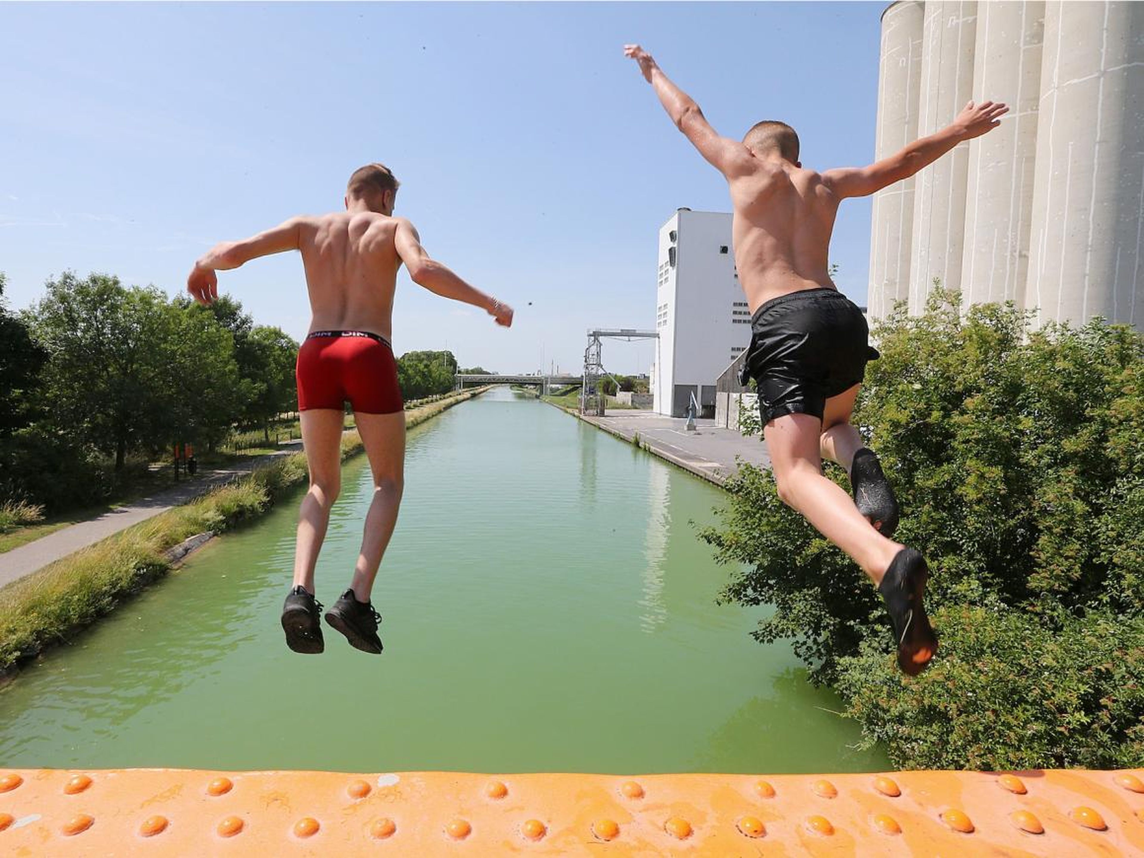 Boys jumping into the canal near the northeastern French city of Reims as temperatures soared on Tuesday.