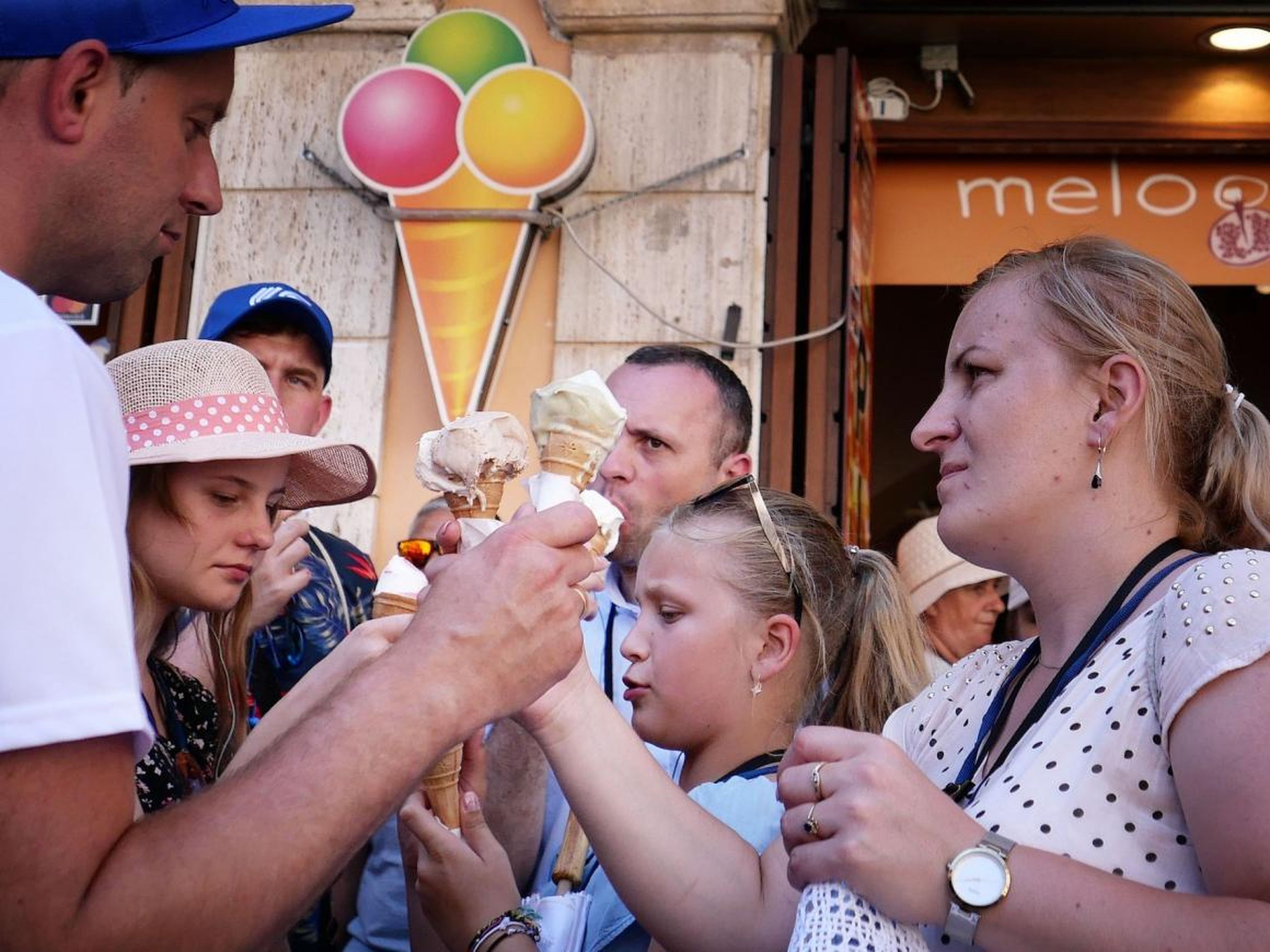 Tourists eat gelato.