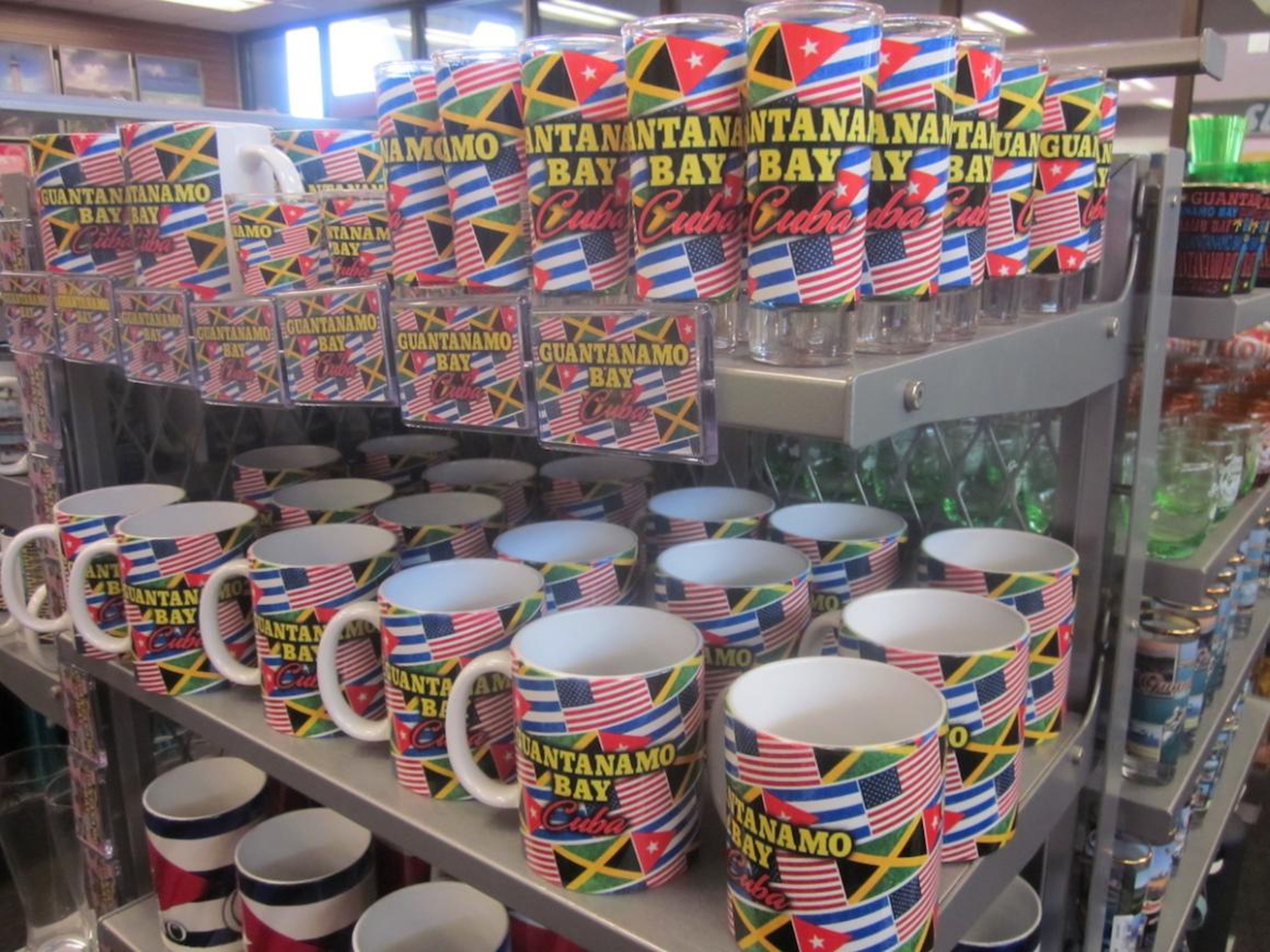 Some other mugs have the flags of the US, Cuba, and Jamaica on them — likely representing the countries whose citizens live on the base.