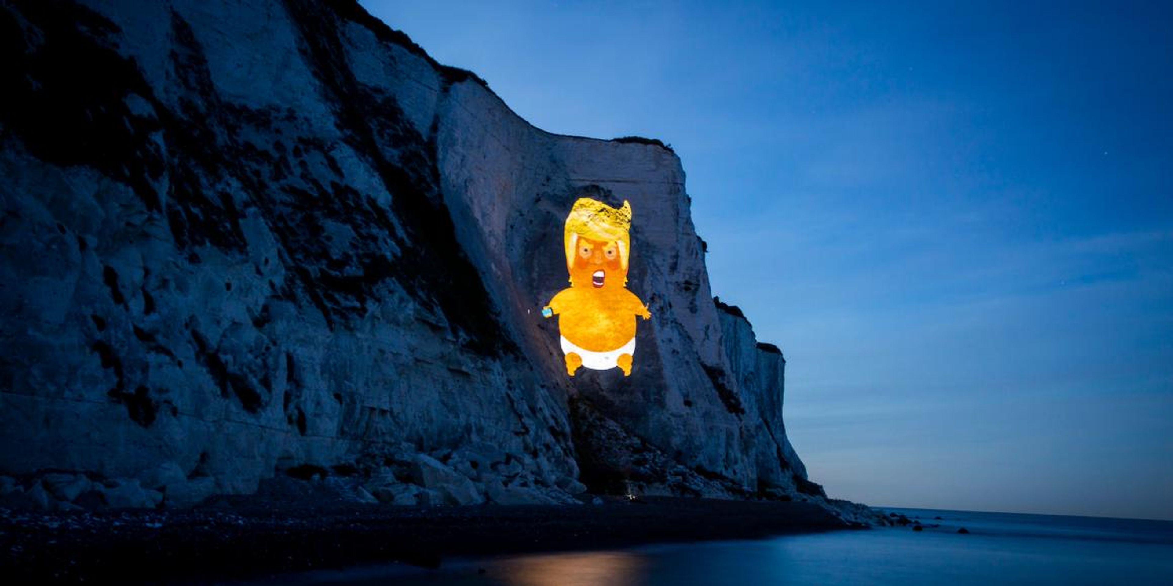 The Trump baby blimp symbol was projected onto the White Cliffs of Dover, on England's southern coast on Sunday.