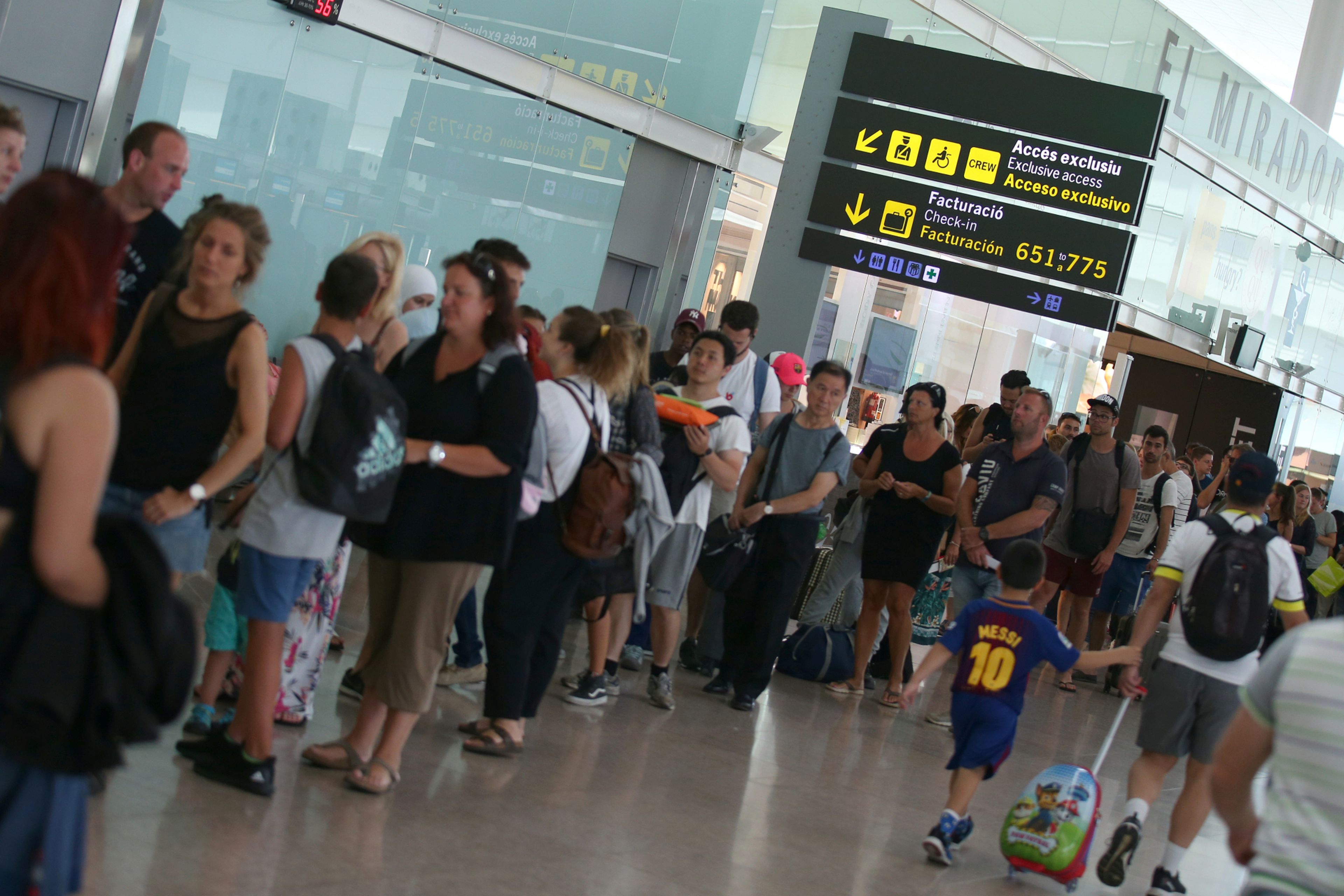 Viajeros hacen cola durante una huelga de personal de seguridad en el aeropuerto de Barcelona