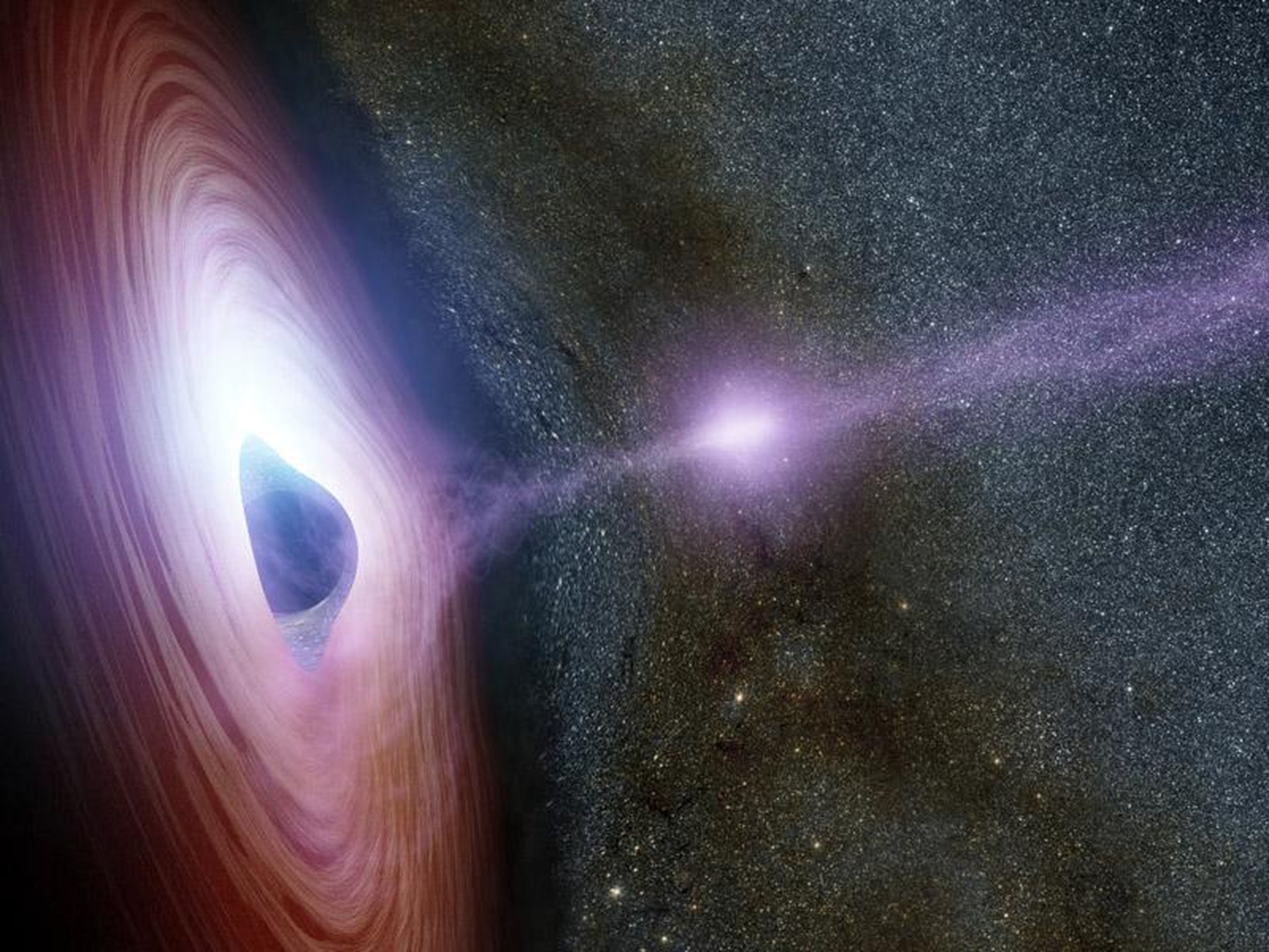An artist's concept of a supermassive black hole surrounded by a swirling disk of material falling onto it.