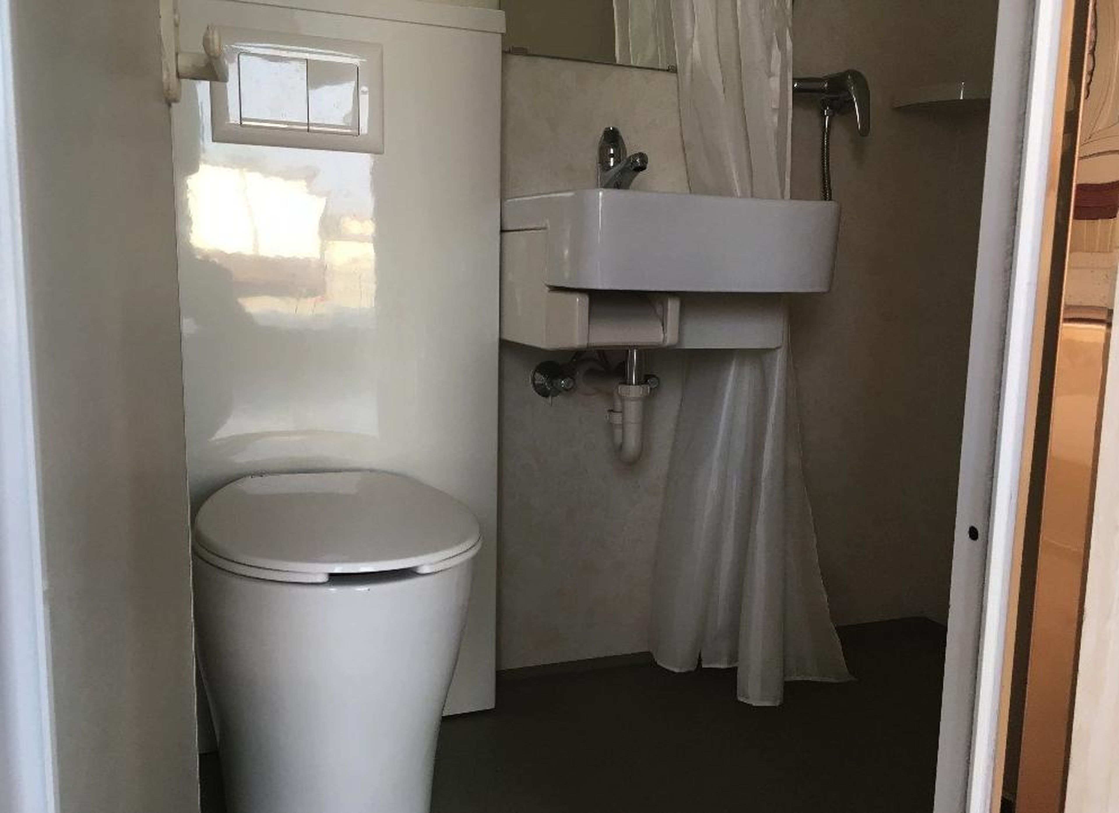 The bathroom has a toilet and a sink.