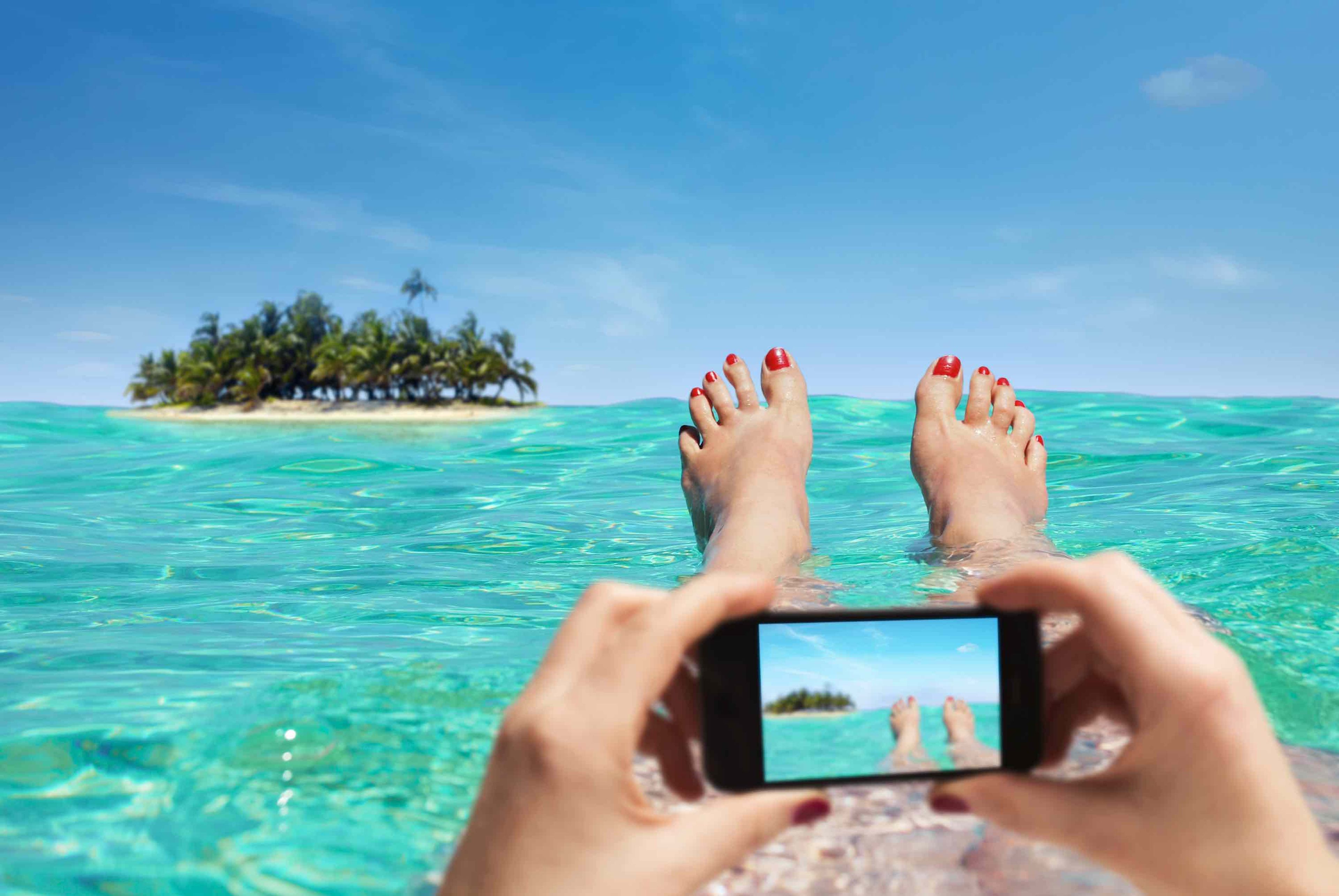 Mujer utilizando un smartphone en la playa.