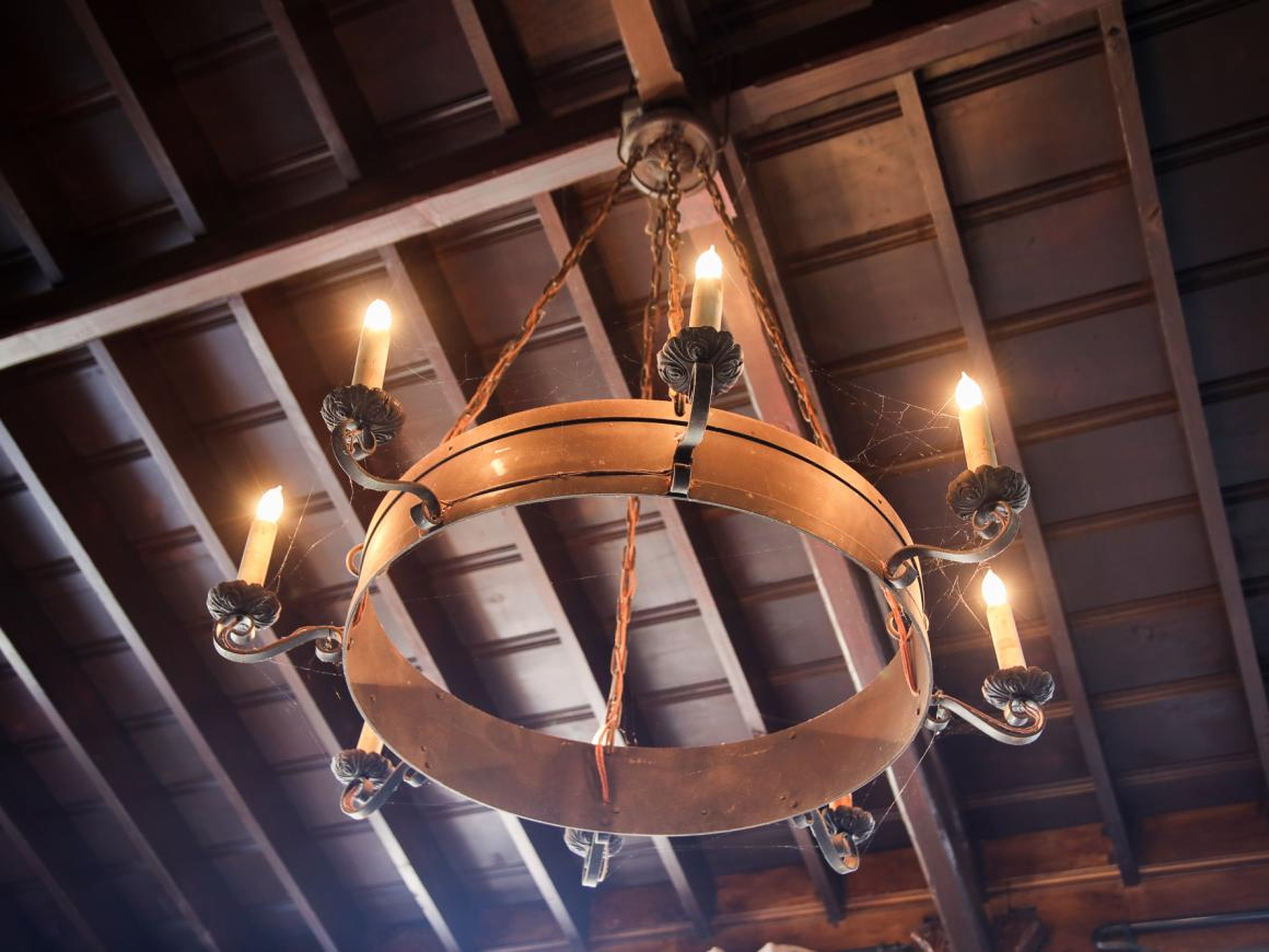 What looks like a medieval chandelier hangs from the ceiling. Gilbert said it came with the property.