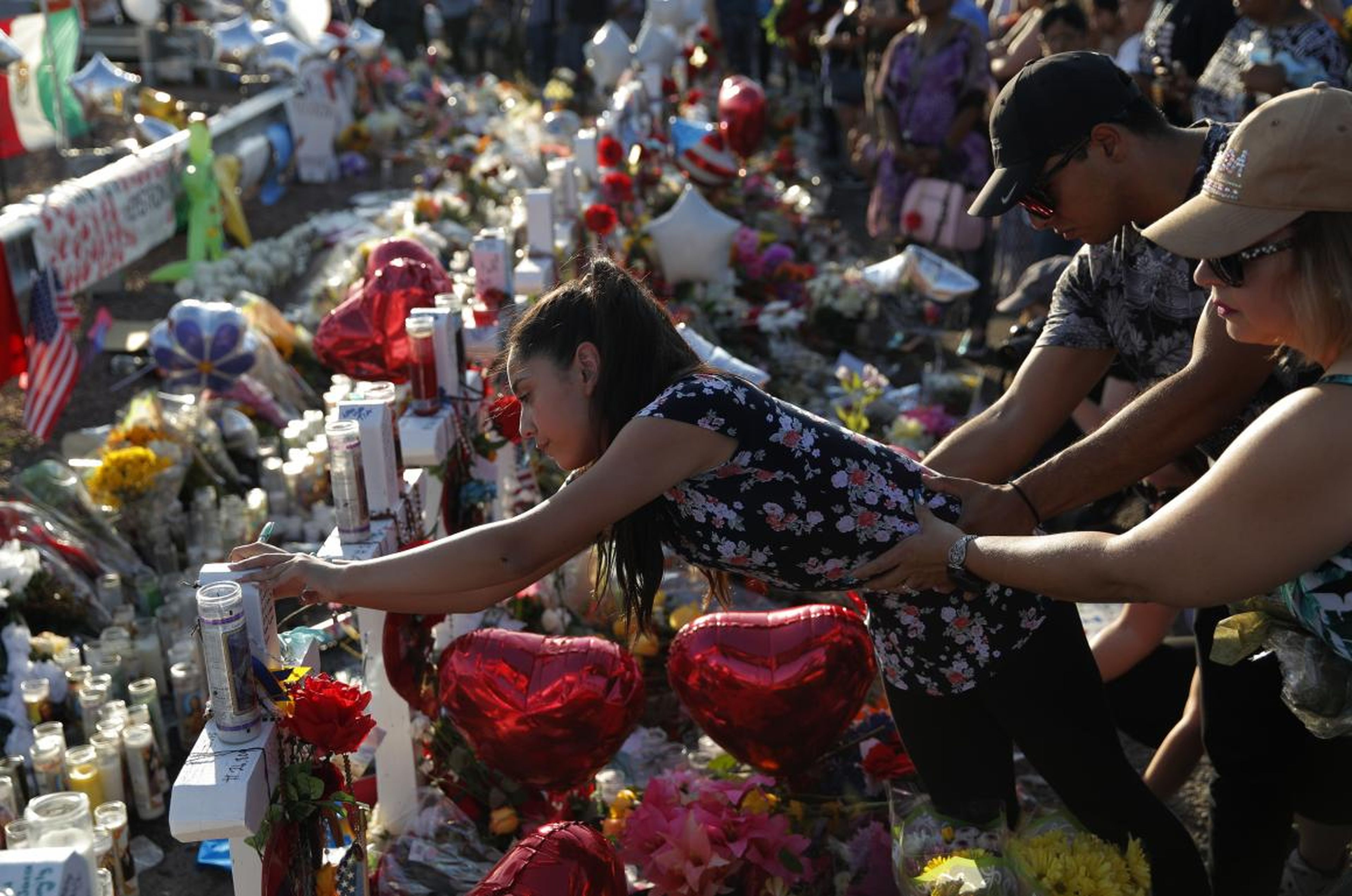A woman at a makeshift memorial at the scene of a mass shooting in El Paso, Texas, on Tuesday.