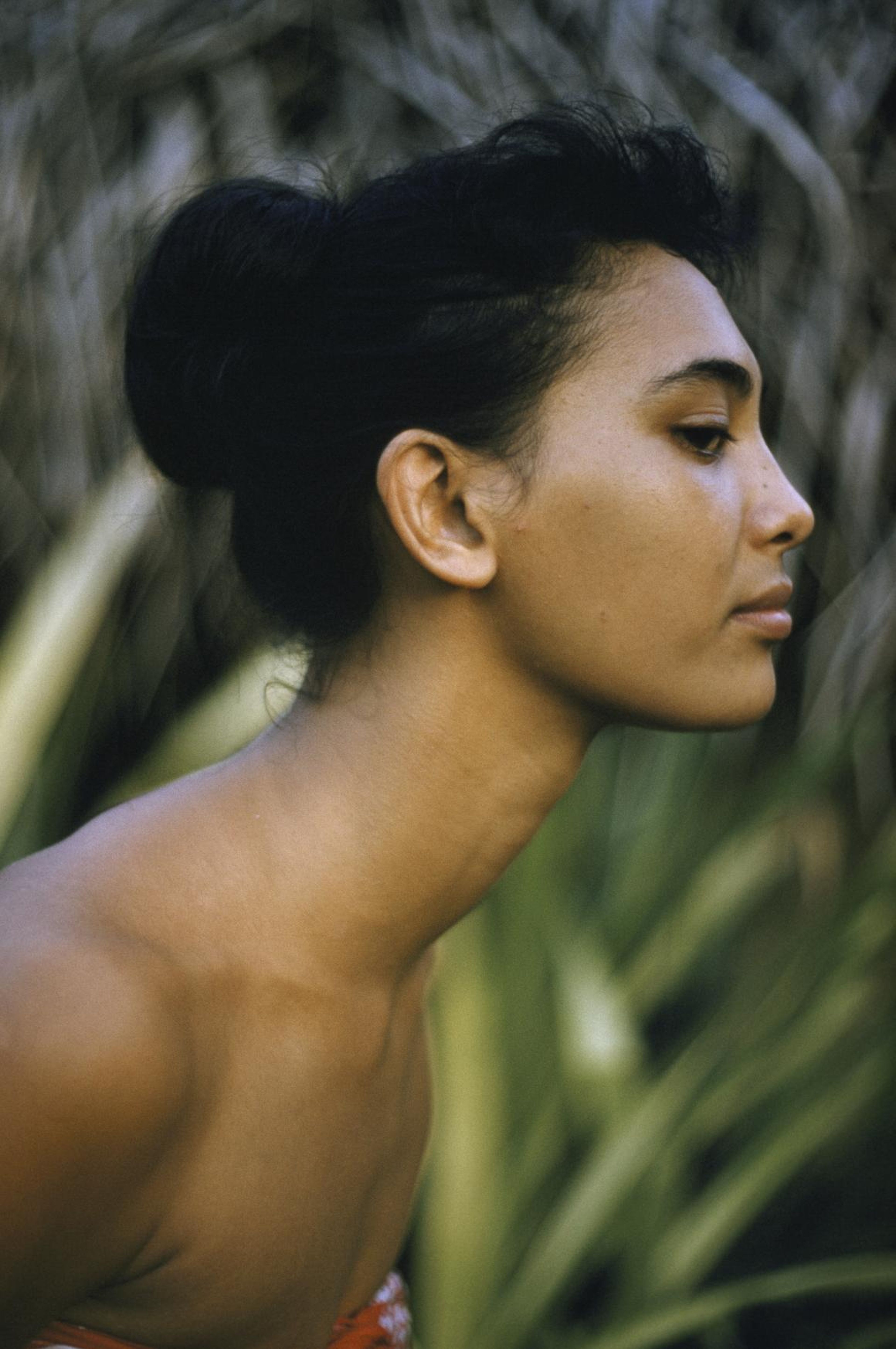 1960s: A Tahitian woman stands in profile.