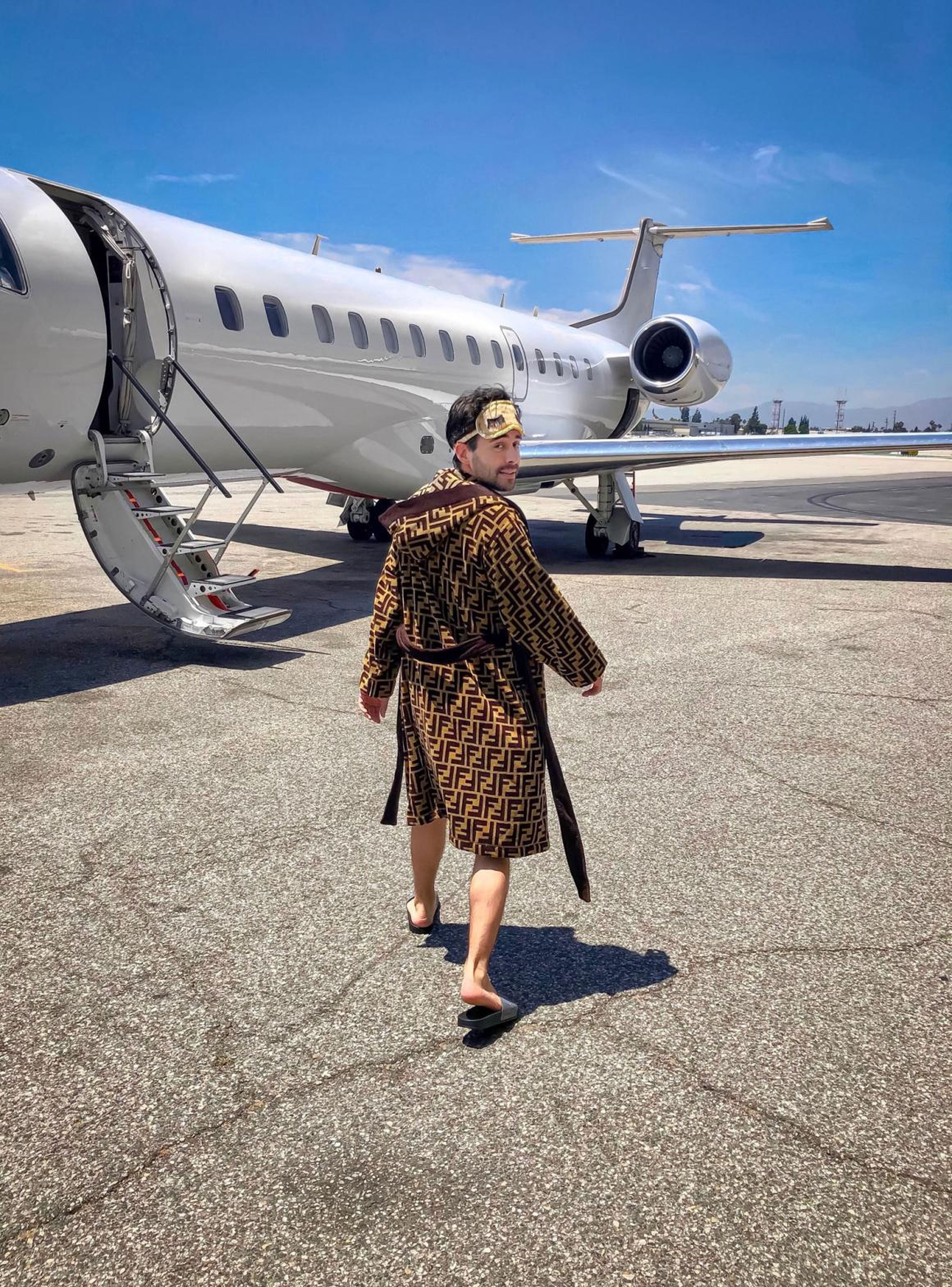 Shannon boarding a private jet while wearing a Fendi robe.