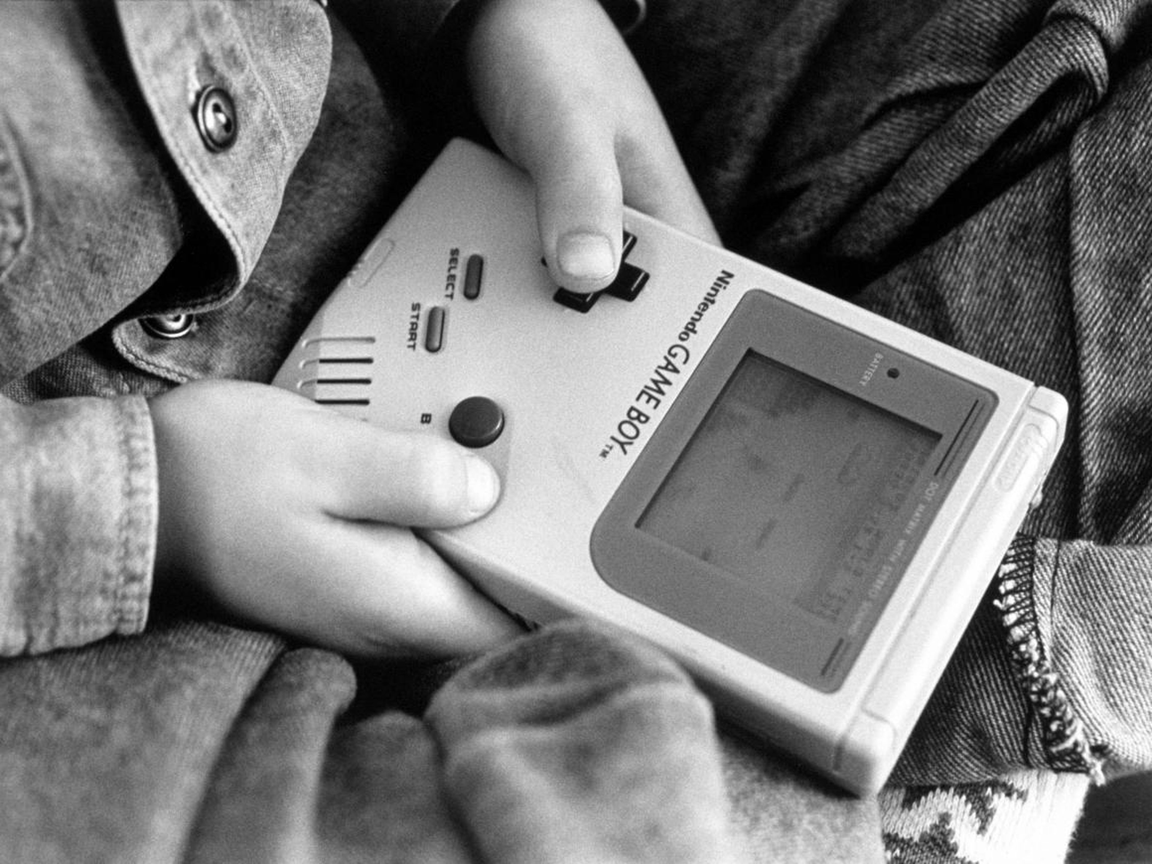 Un niño jugando con uno de los primeros Nintendo Game Boys.