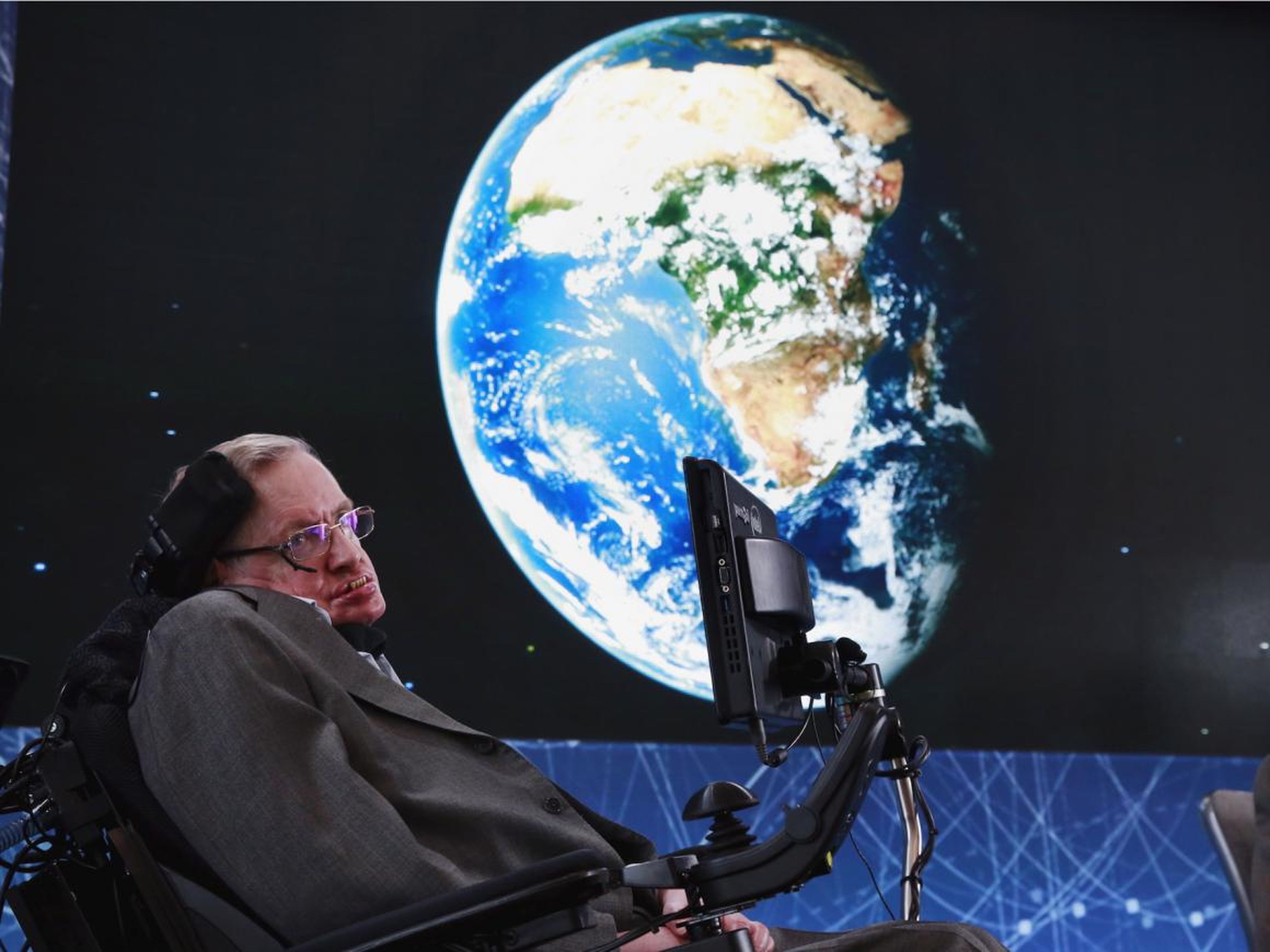 Stephen Hawking sits on stage during an announcement of the Breakthrough Starshot initiative with investor Yuri Milner in New York, April 12, 2016.
