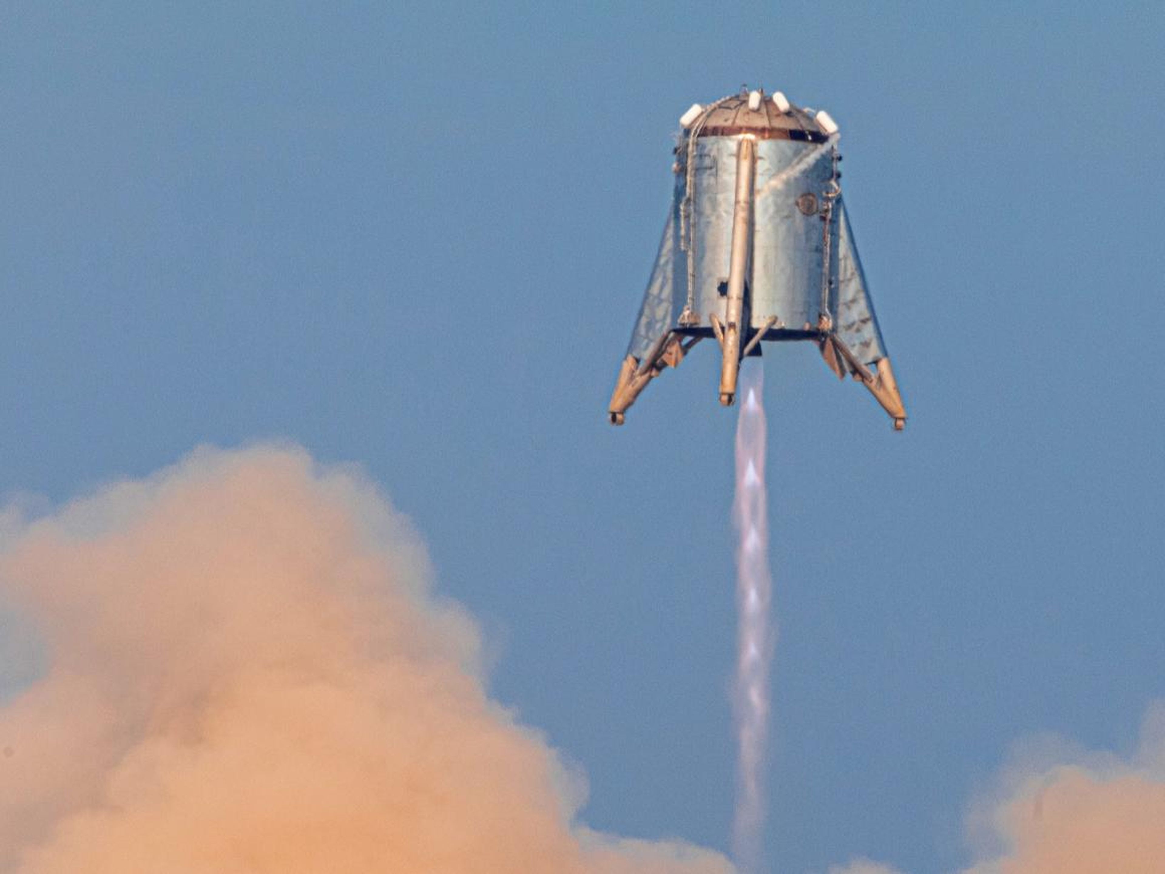 Starhopper — SpaceX's first Mars Starship prototype — hovering over its launchpad during a test flight in Boca Chica, Texas, last Tuesday.