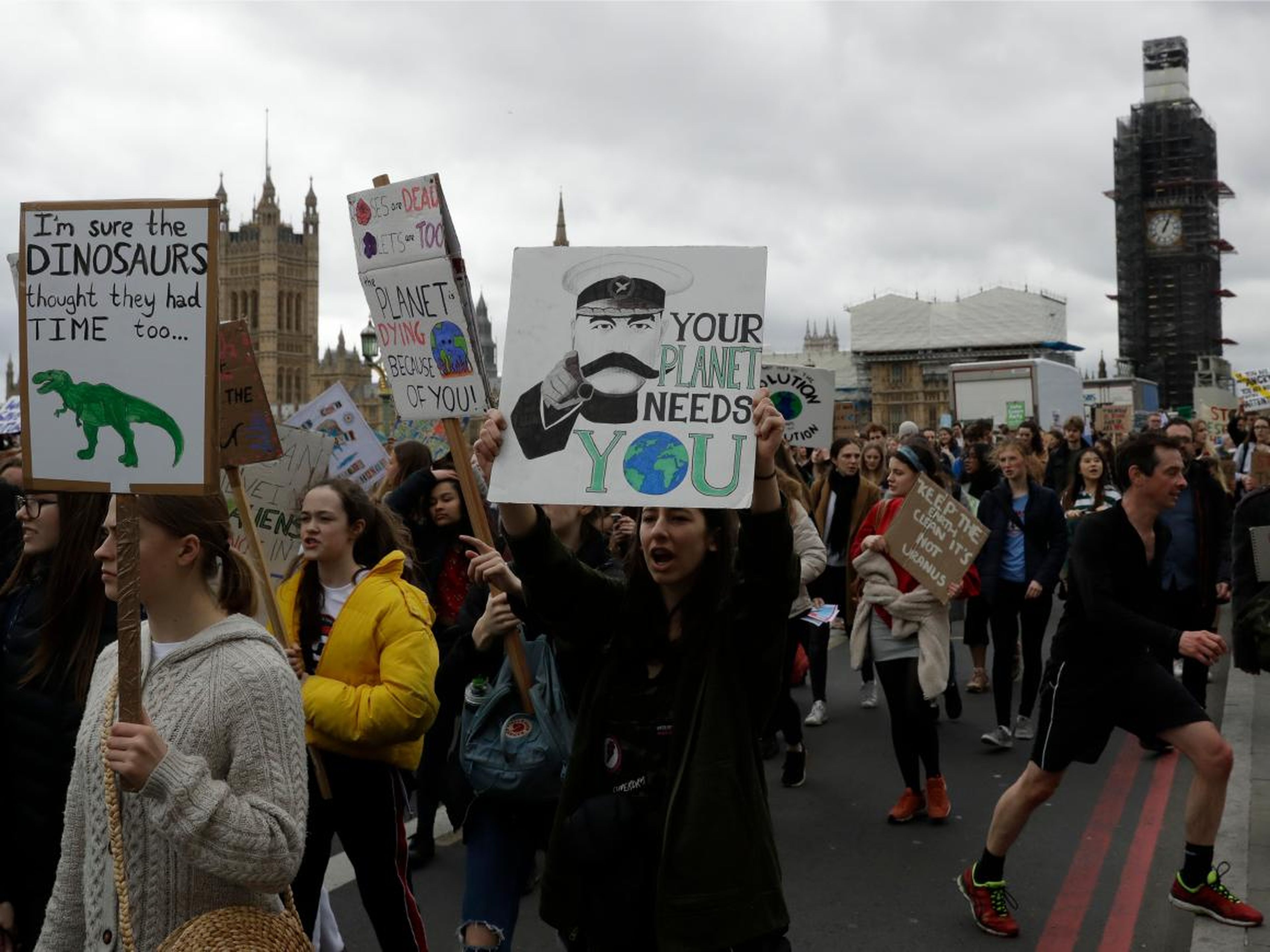 Students march across Westminster Bridge as they take part in a climate protest in London, March 15, 2019.