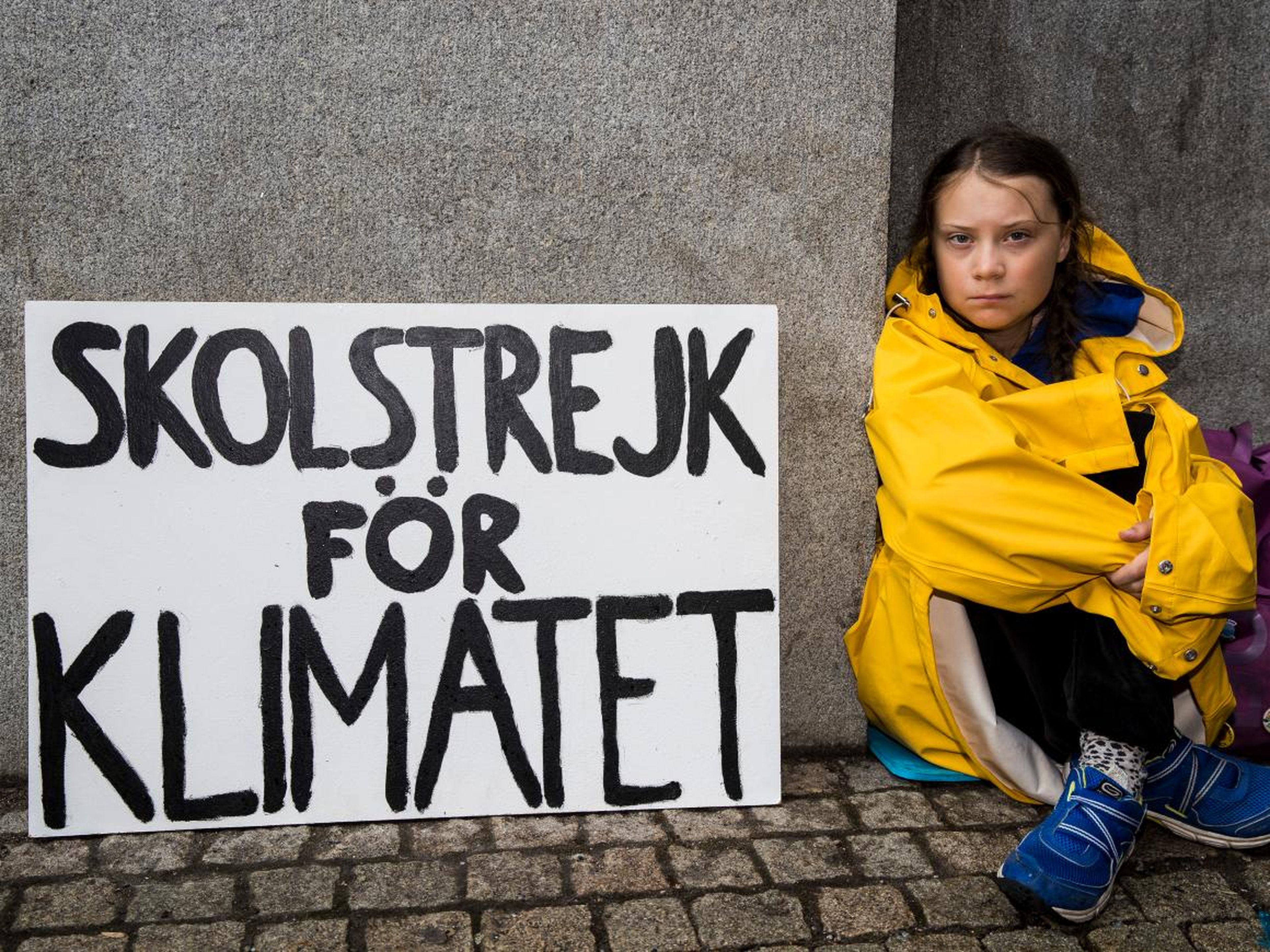 Greta Thunberg sits outside of Riksdagen, the Swedish parliament building, on August 28, 2018 in Stockholm, Sweden.
