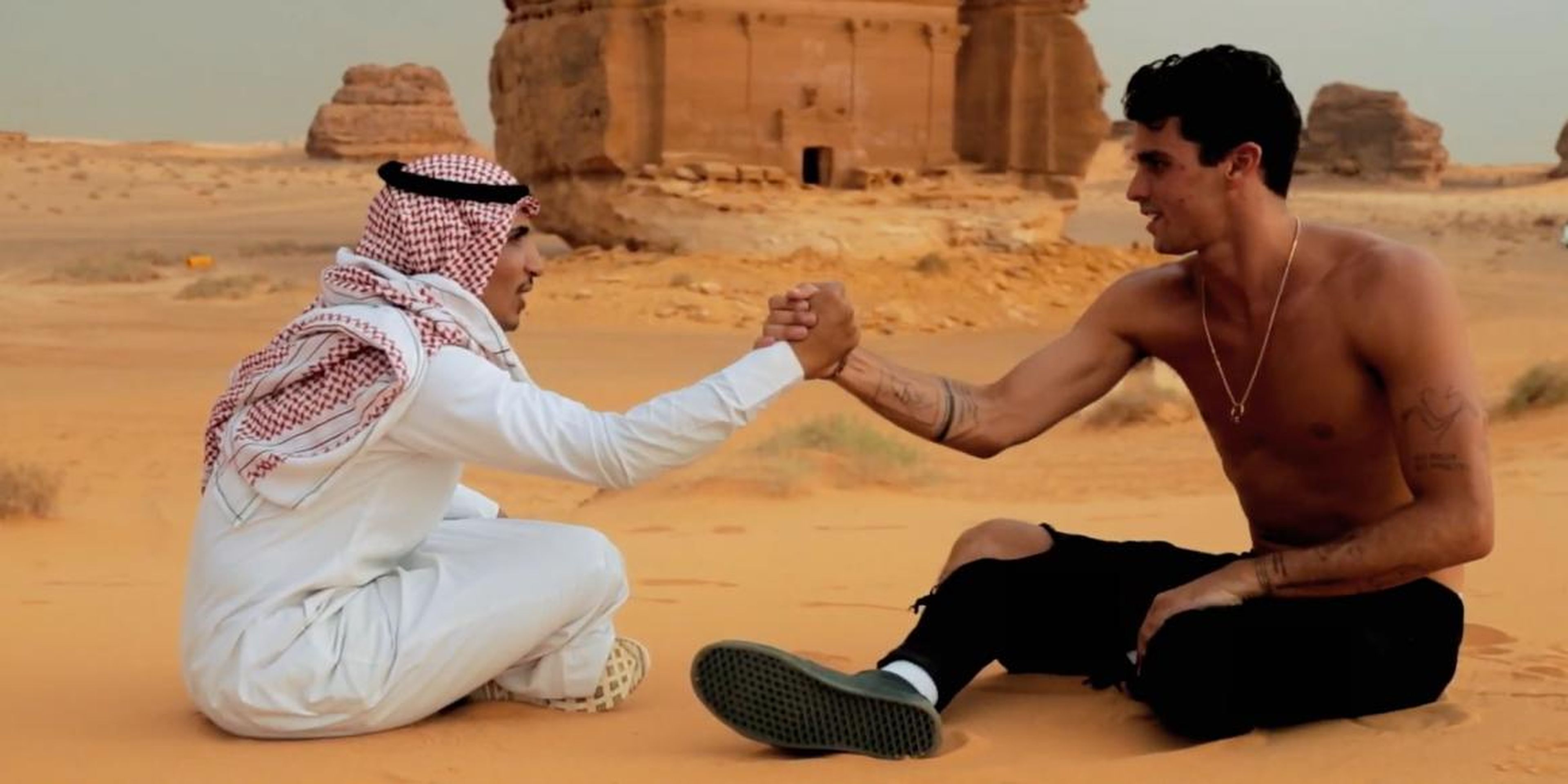The Instagram star Jay Alvarrez with a Saudi man wearing a keffiyeh and thawb at Saudi Arabia's heritage center of Mada'in Saleh.