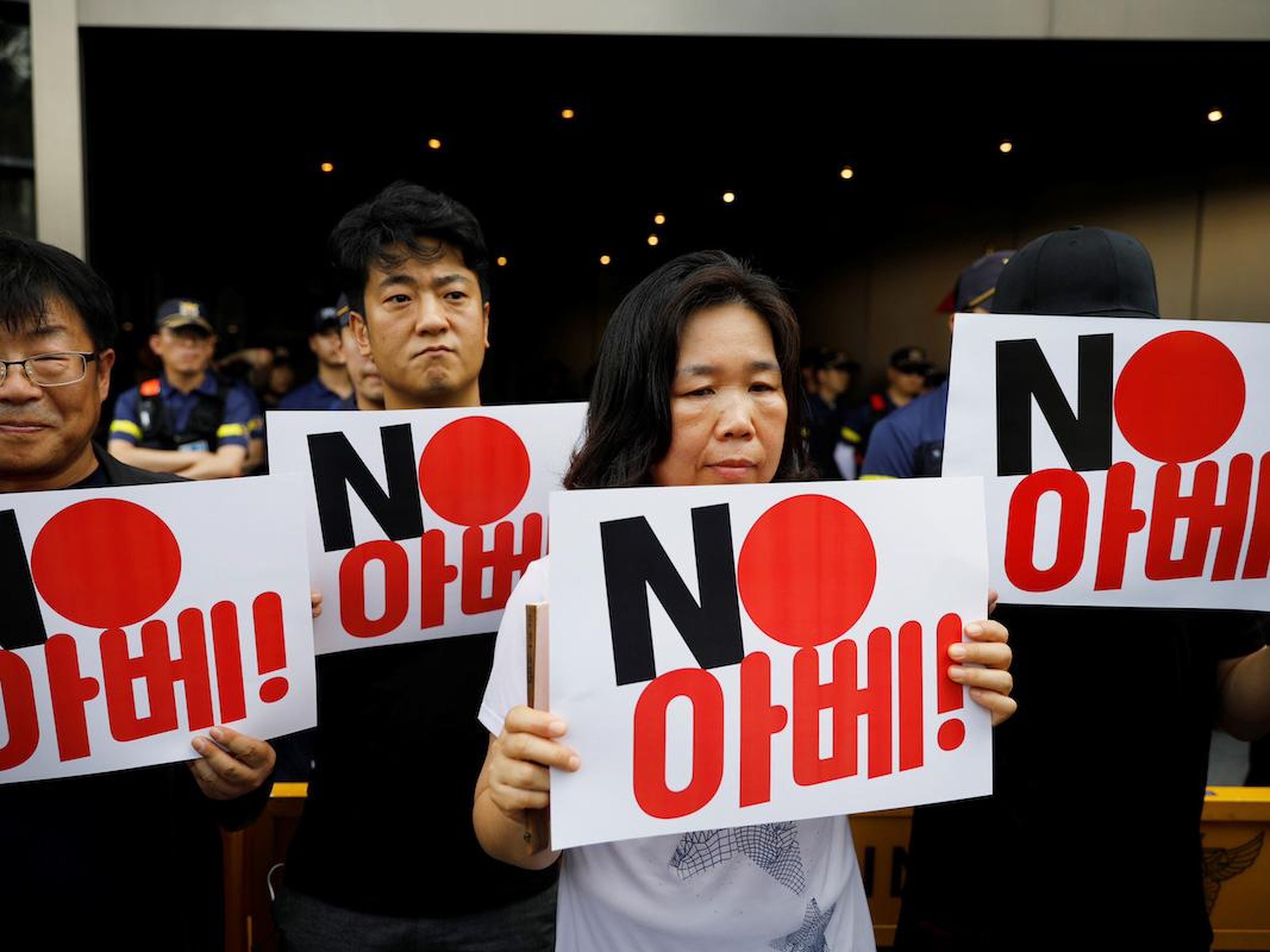 Protesters holding up signs that say "No Abe," referring to Japanese Prime Minister Shinzo Abe, outside the Japanese embassy in Seoul, South Korea, in August 2019.