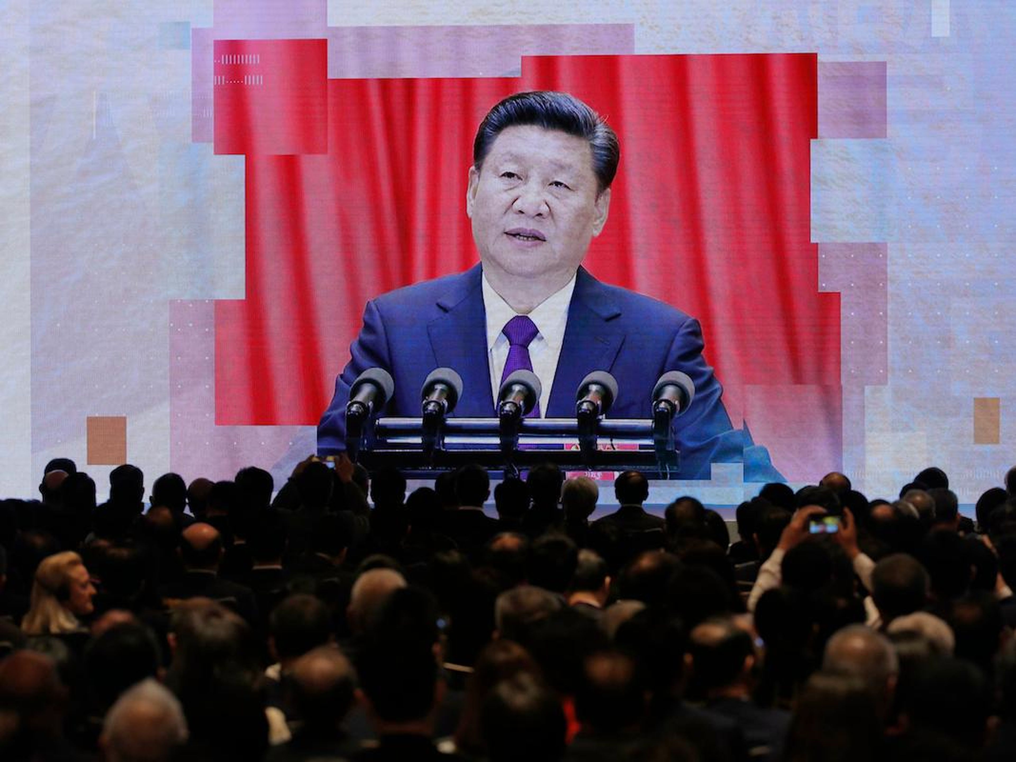 A screen shows Chinese President Xi Jinping during a symposium in Hong Kong on February 21, 2019.