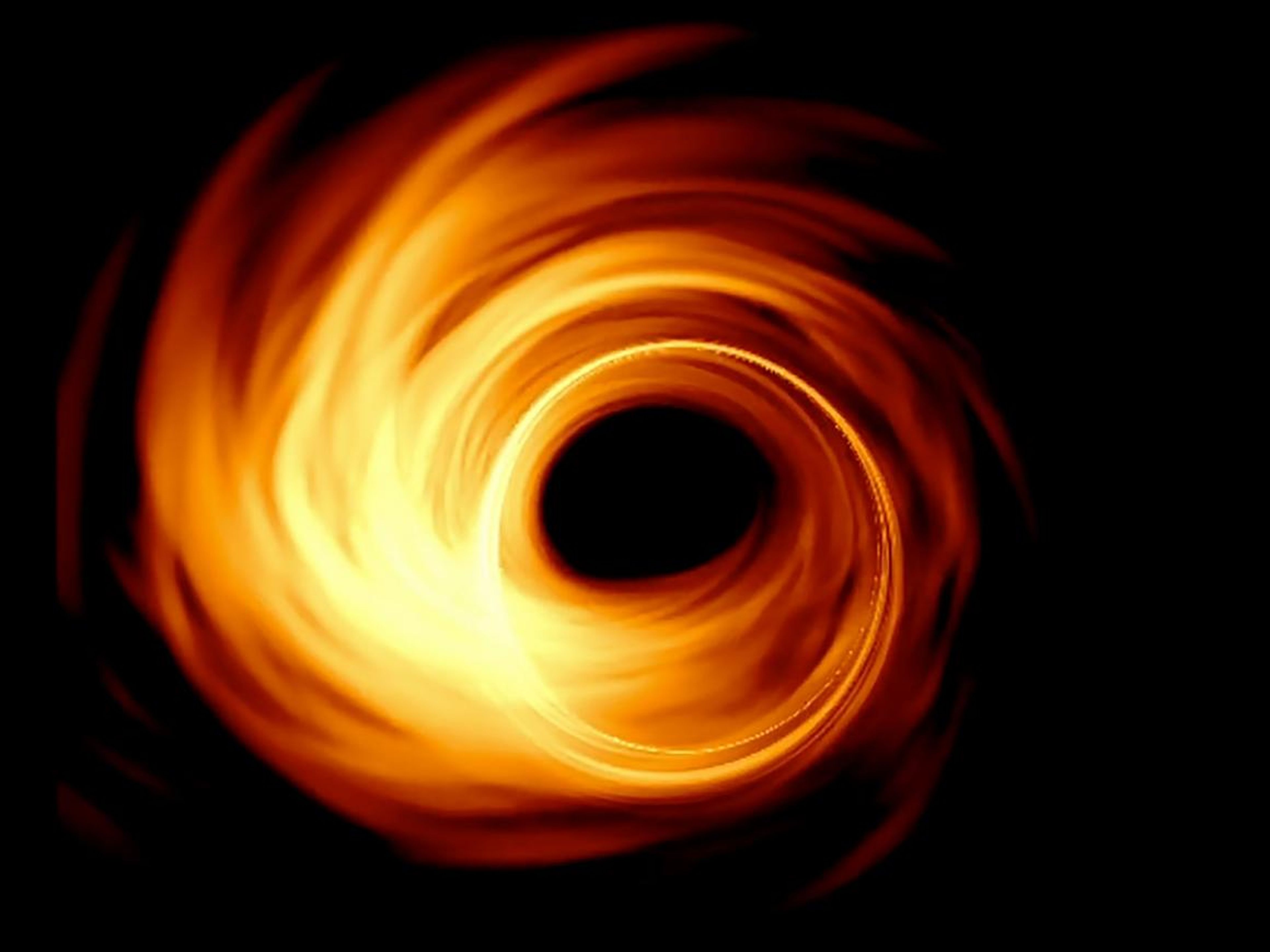 Una simulación por ordenador de cómo el disco de acreción de un agujero negro supermasivo y su horizonte de sucesos (o "sombra" interna) podría aparecer ante un telescopio en la Tierra.