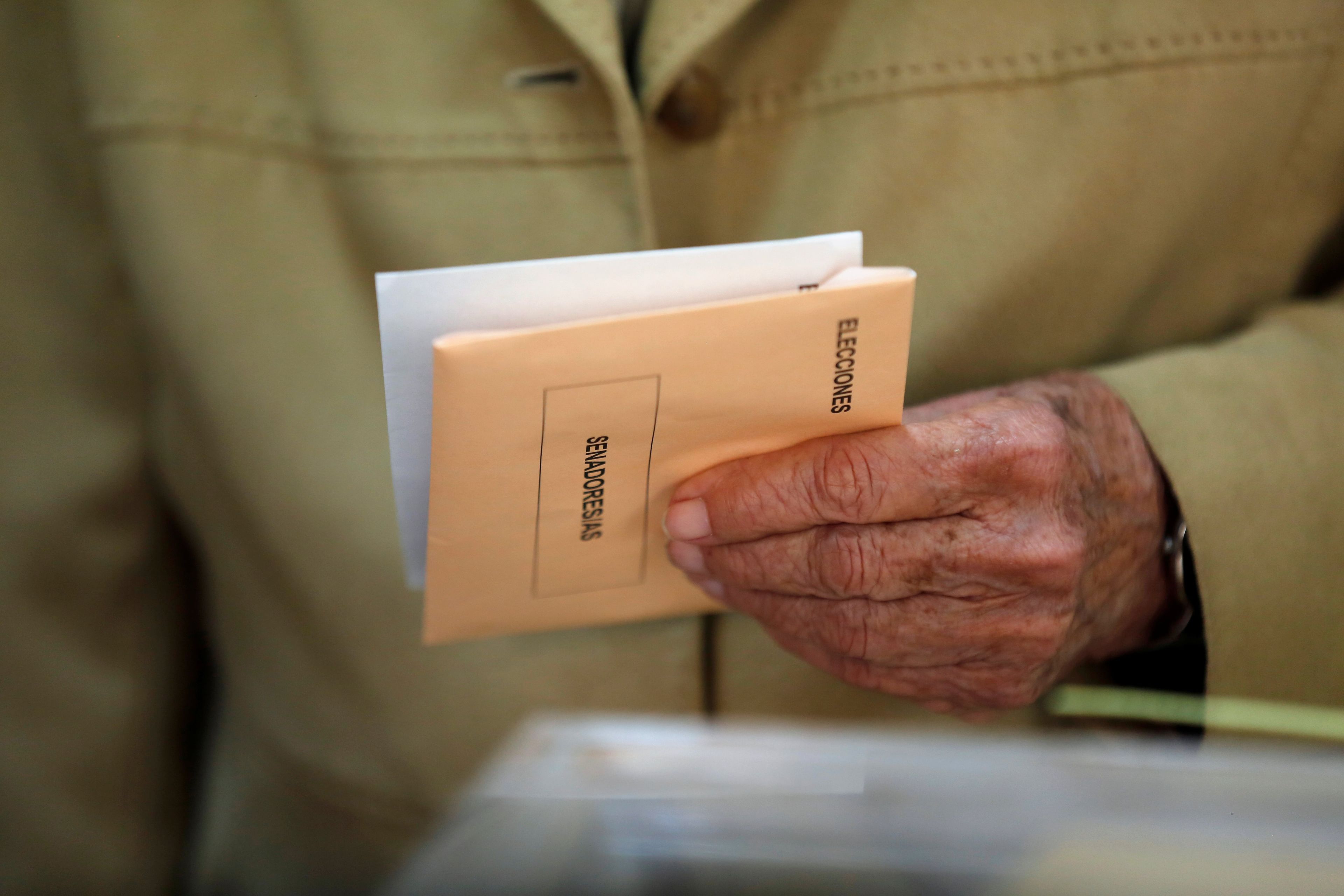 Un hombre con sus papeletas para votar en las elecciones generales.