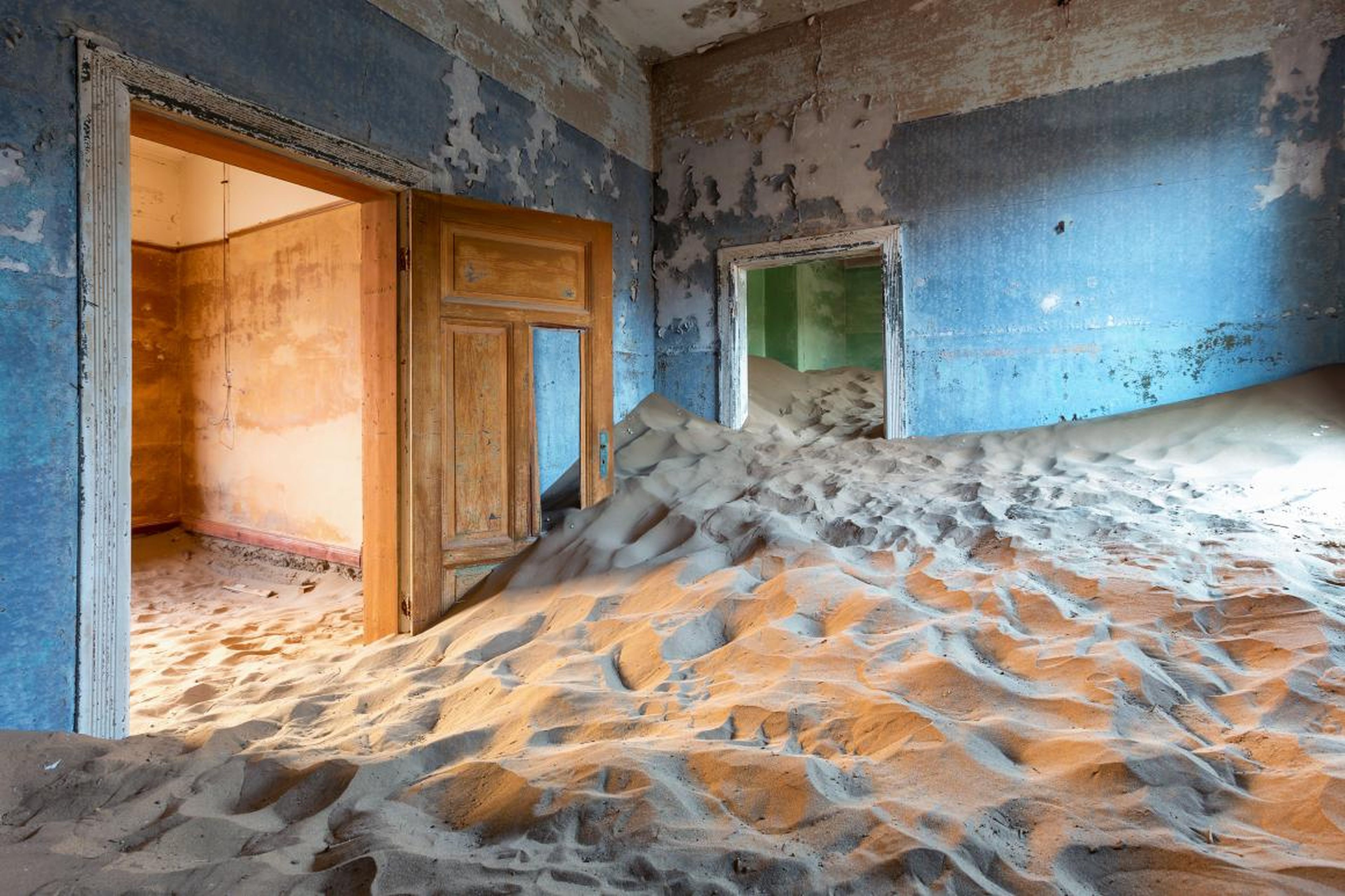 A building invaded by sand dunes in Kolmanskop.