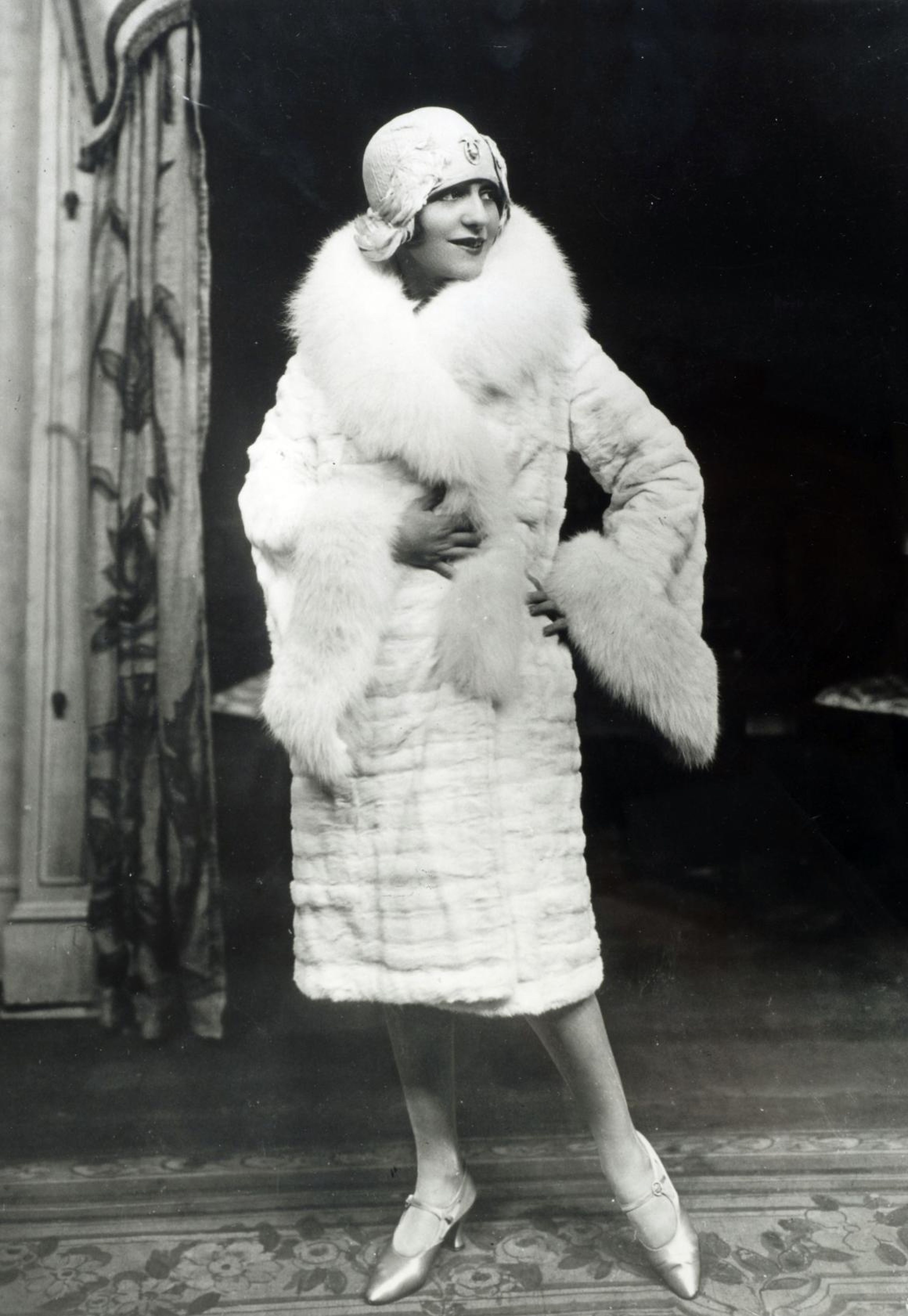 A woman wearing a fur coat and hat in the '20s.