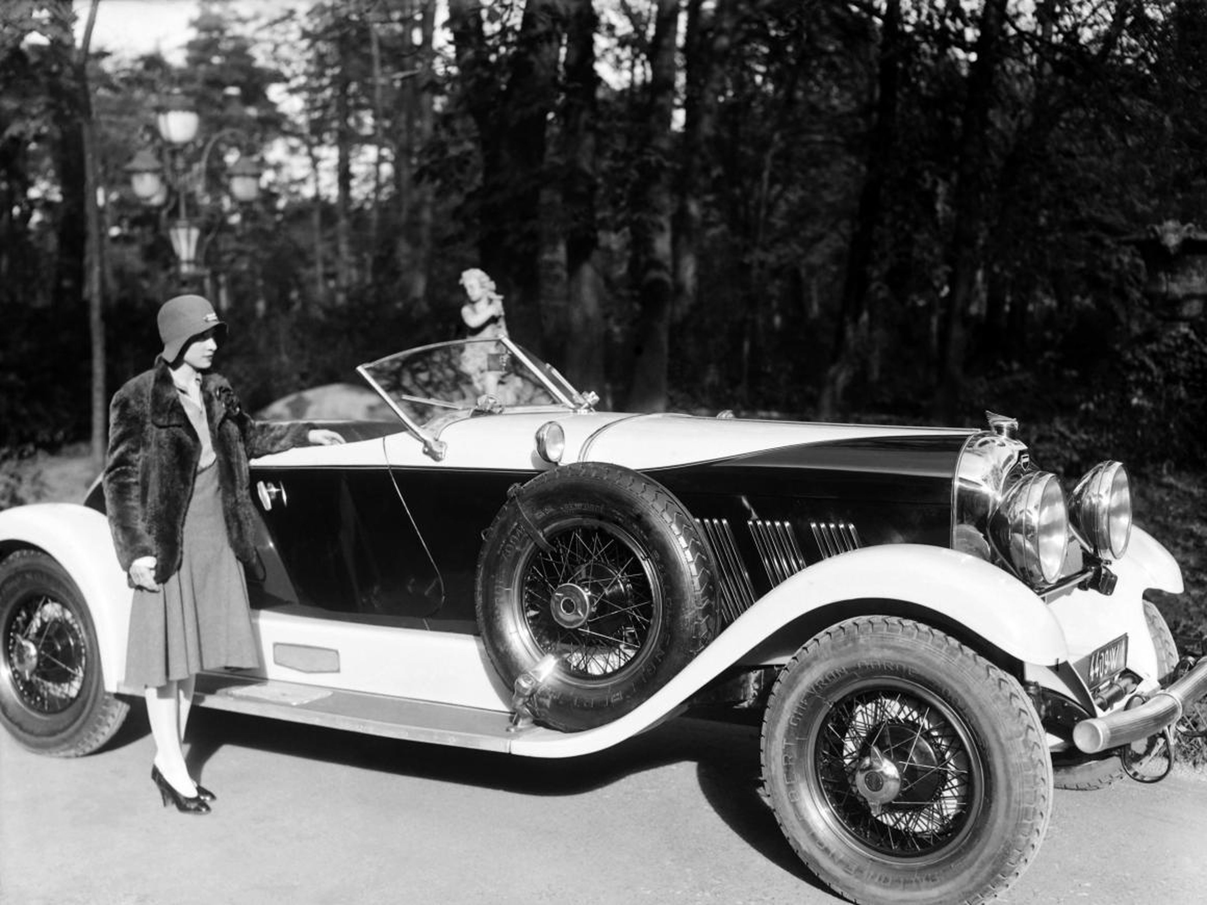 A woman with a Chrysler vehicle, circa 1920s.