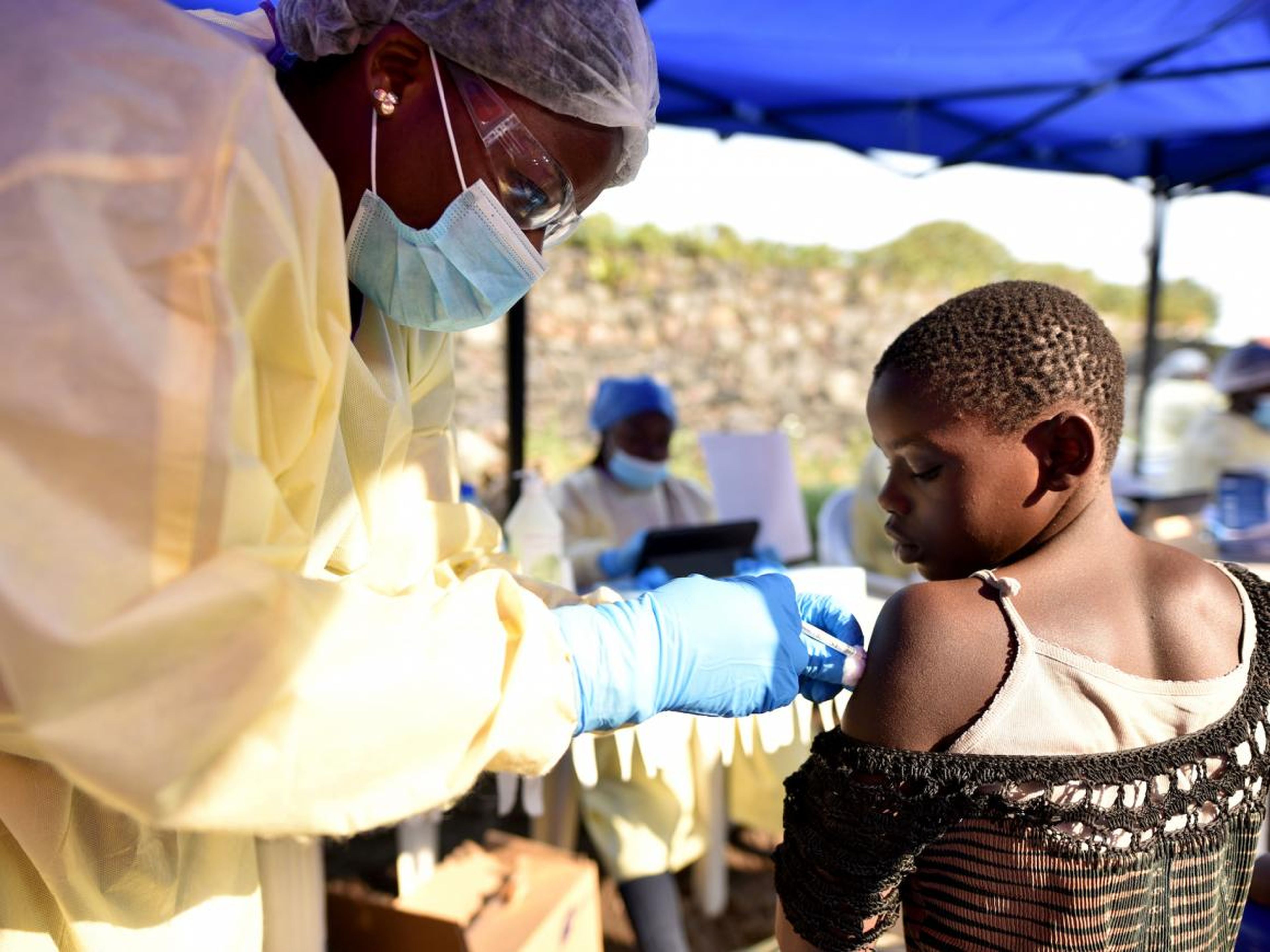 A Congolese health worker administers Ebola vaccine to a child.
