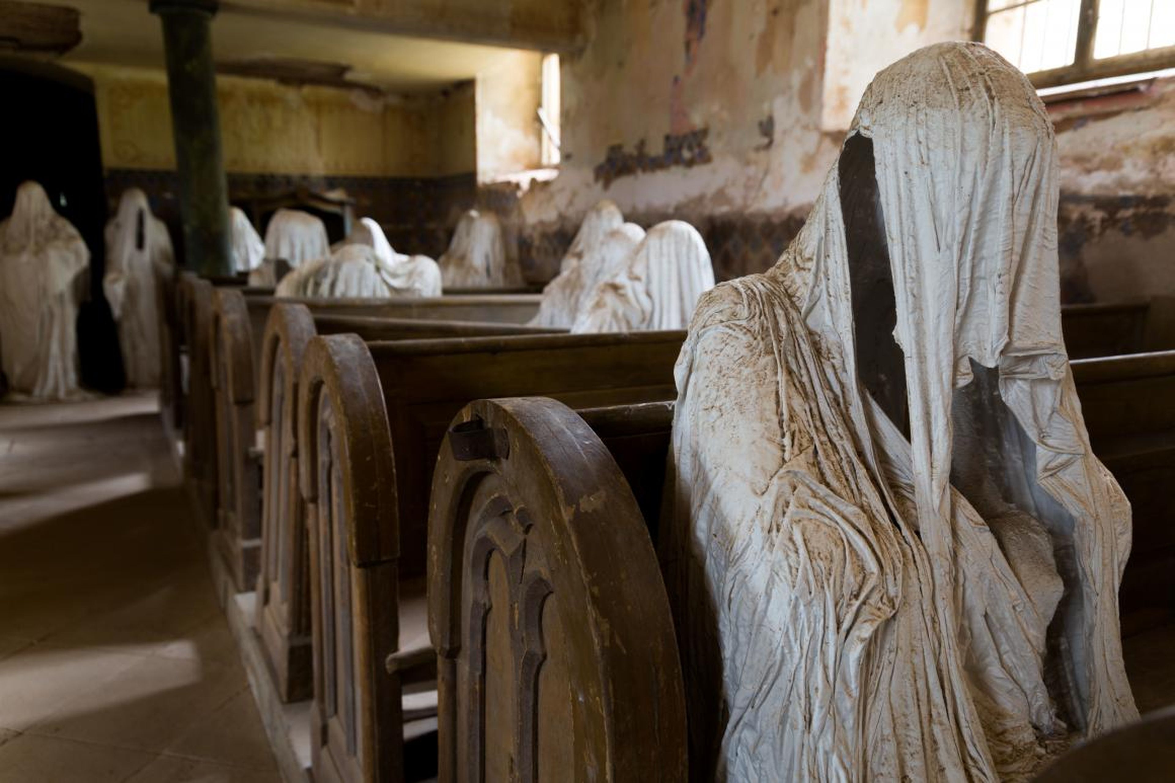 Ghostly figures line the pews in St. George's Basilica.