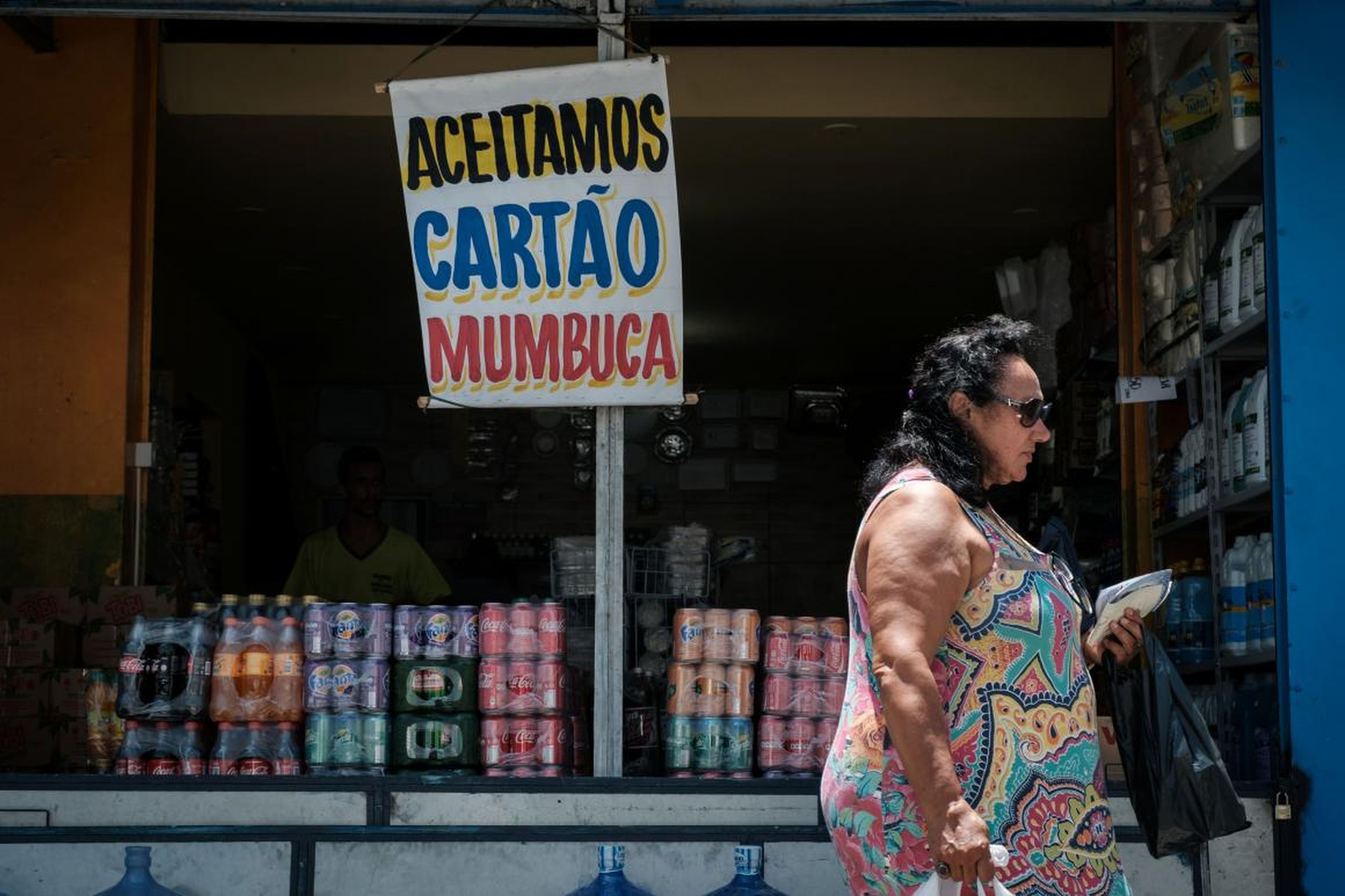 A store shows a placard reading "Mumbuca card accepted" in Marica, Brazil.