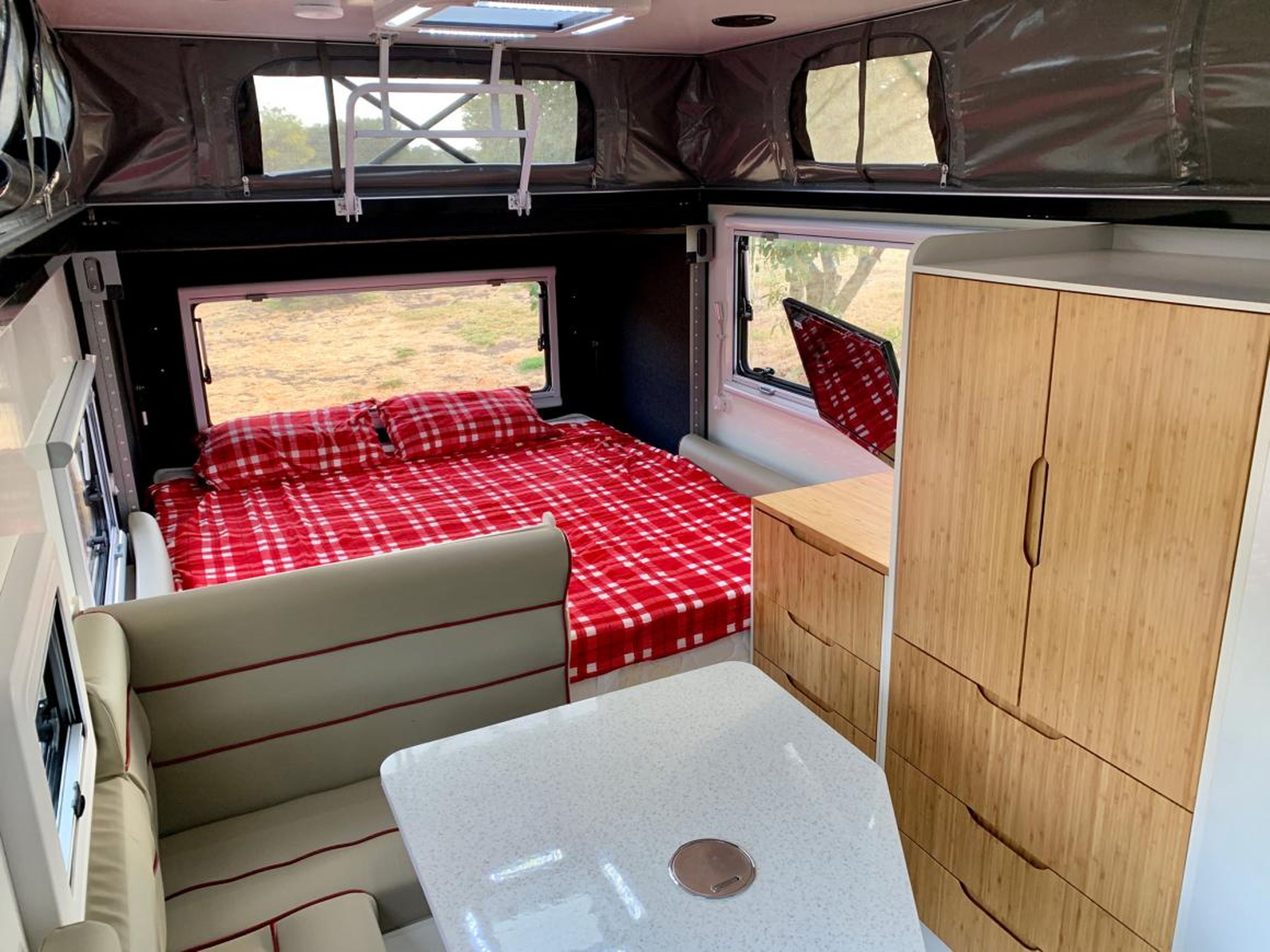 The interior has a king bed and two twin bunk beds.