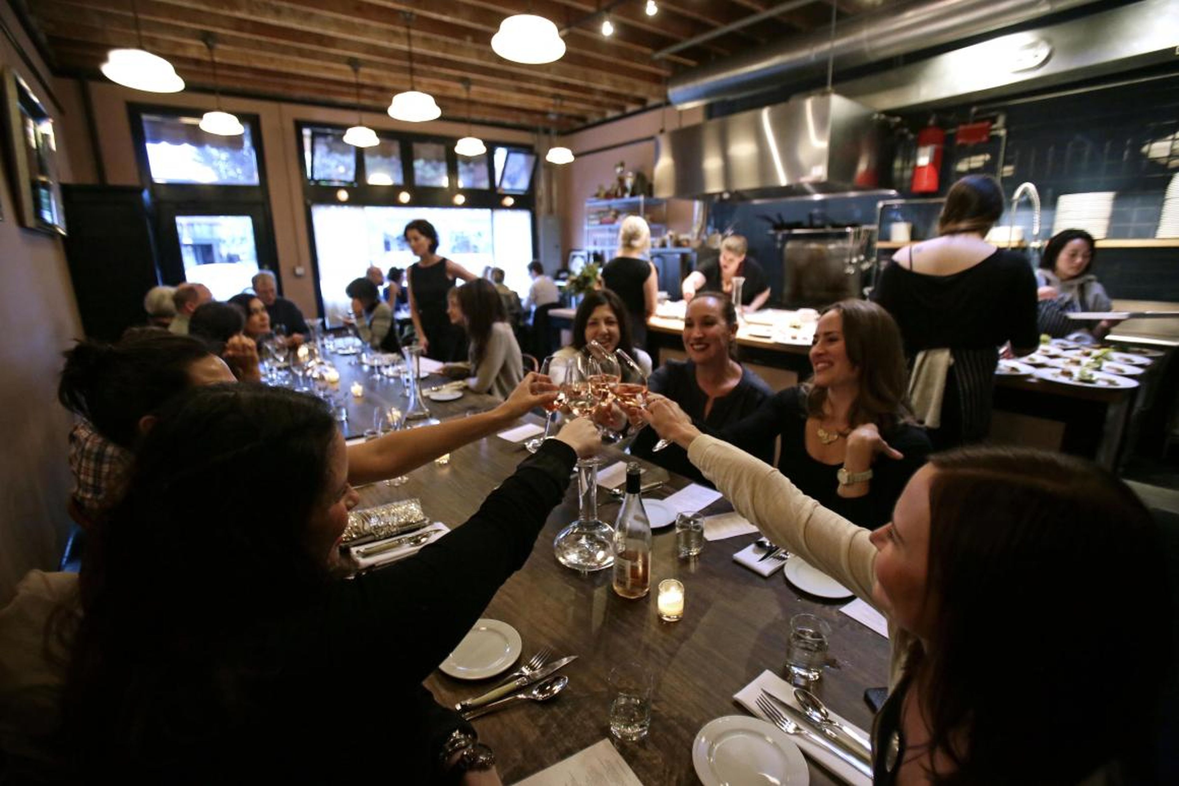 People toasting at Naomi Pomeroy's Beast restaurant in Portland.