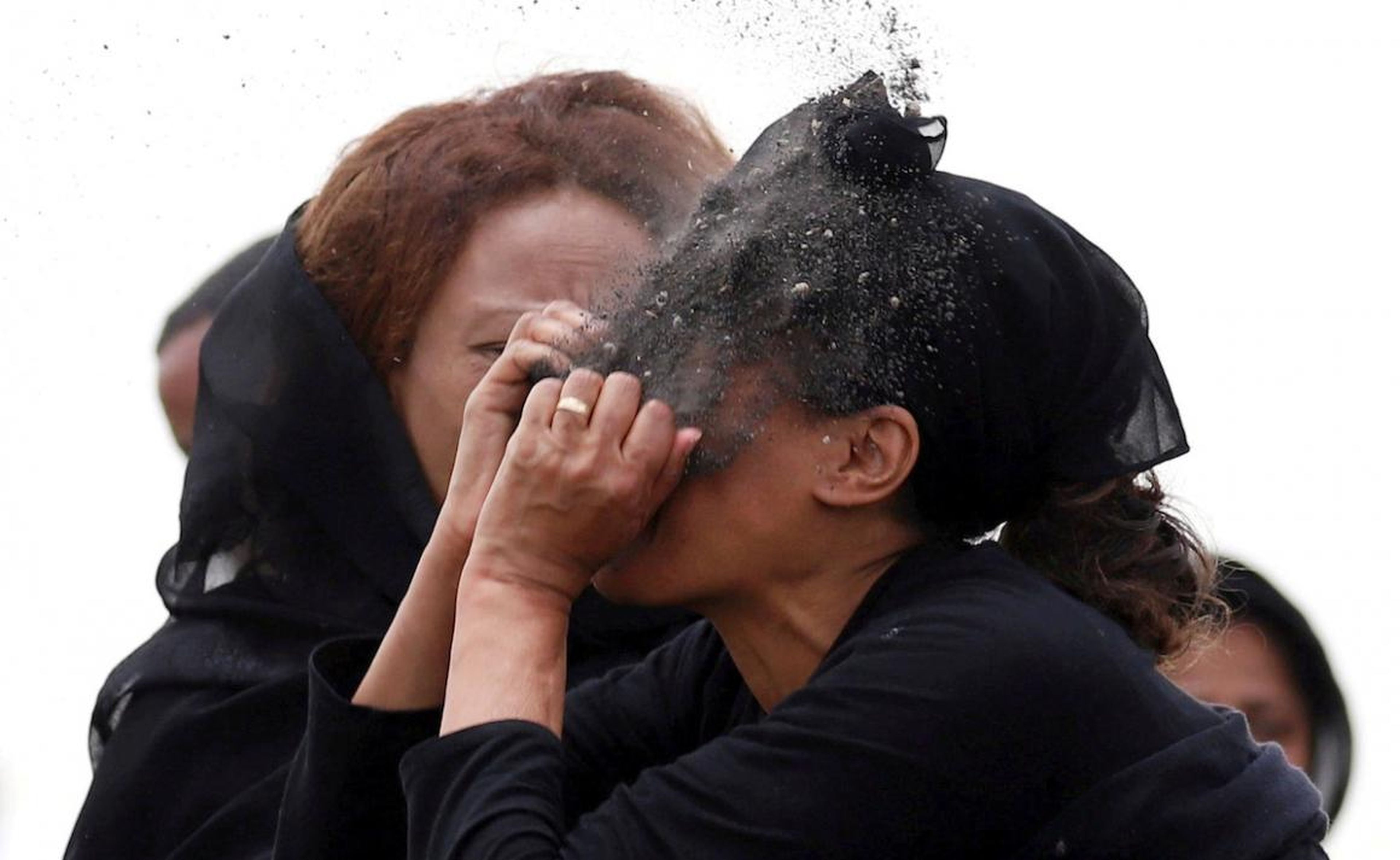 A relative puts soil on her face as she mourns at the scene of the Ethiopian Airlines Flight ET 302 plane crash, near the town Bishoftu, near Addis Ababa, Ethiopia, on March 14.
