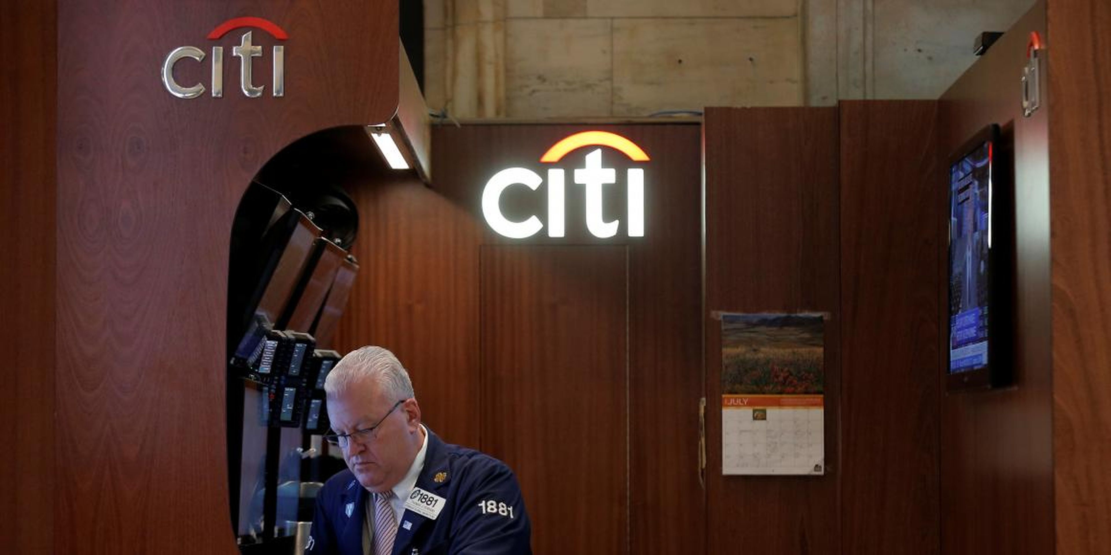 Citi trader Thomas Ferrigno works in his company's booth on the floor of the New York Stock Exchange (NYSE) in New York City, U.S., July 27, 2016.