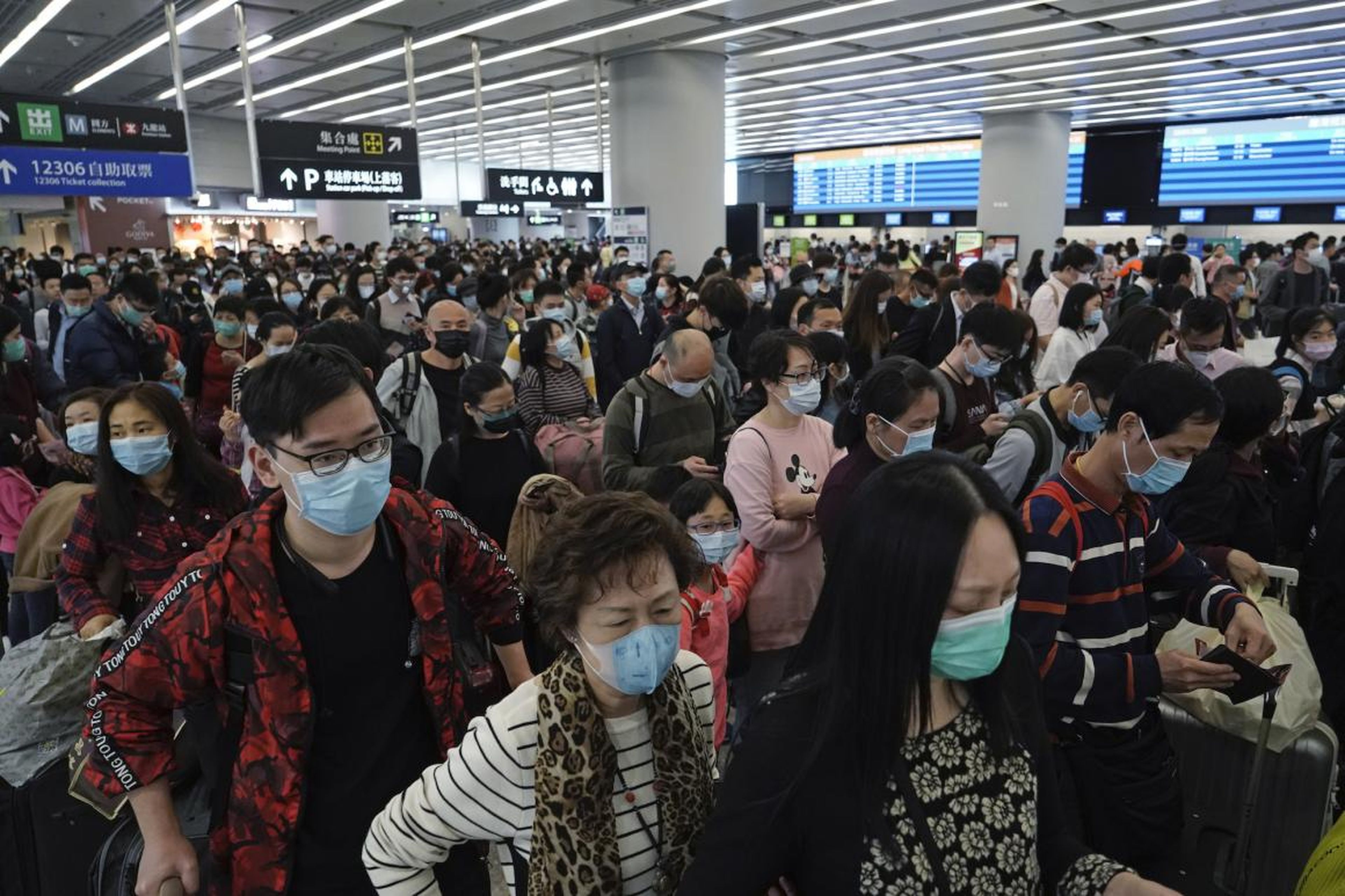Passengers wear protective face masks at the departure hall of the high-speed train station in Hong Kong, January 23, 2020.