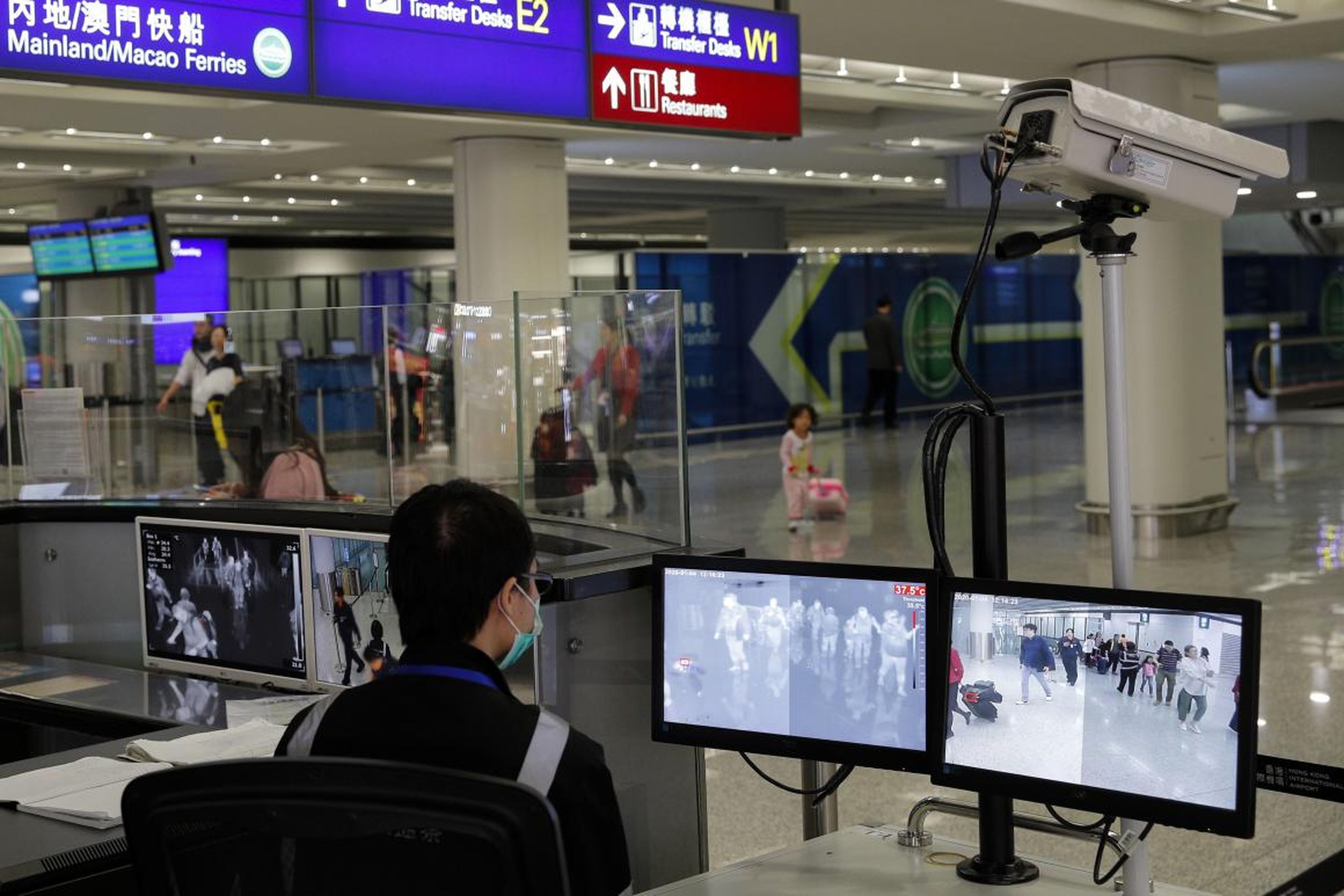 A health surveillance officer monitors passengers arriving at the Hong Kong International Airport on January 4, 2020.